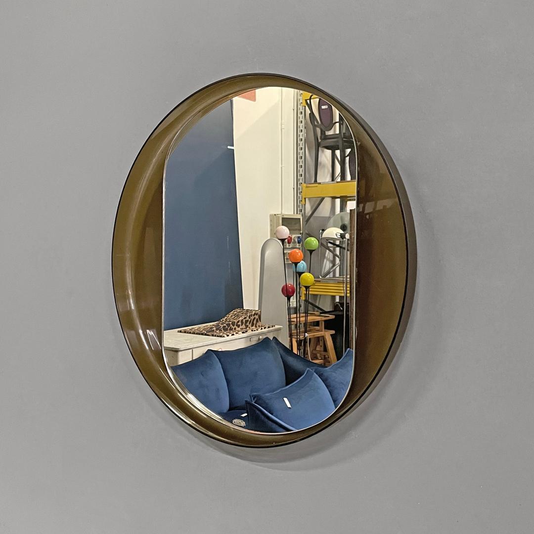 Italian modern round wall mirror in semitransparent brown plastic, 1970s  In Good Condition In MIlano, IT