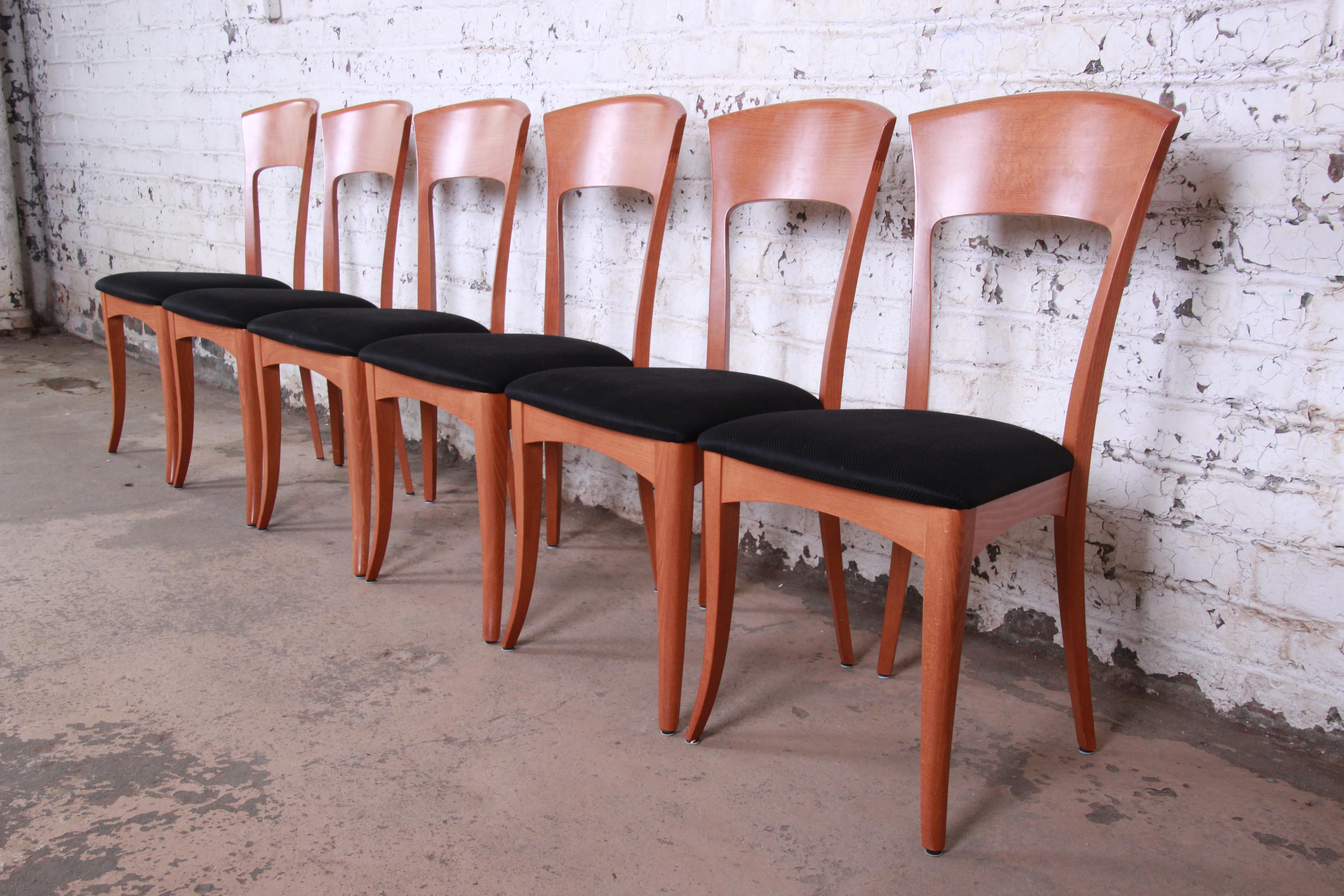 A gorgeous set of six sculpted teak Italian dining chairs by A. Sibau. The chairs feature solid teak frames with beautiful wood grain and sleek mid-century modern design. Black upholstery is original. Each chair is signed. The chairs are solid and