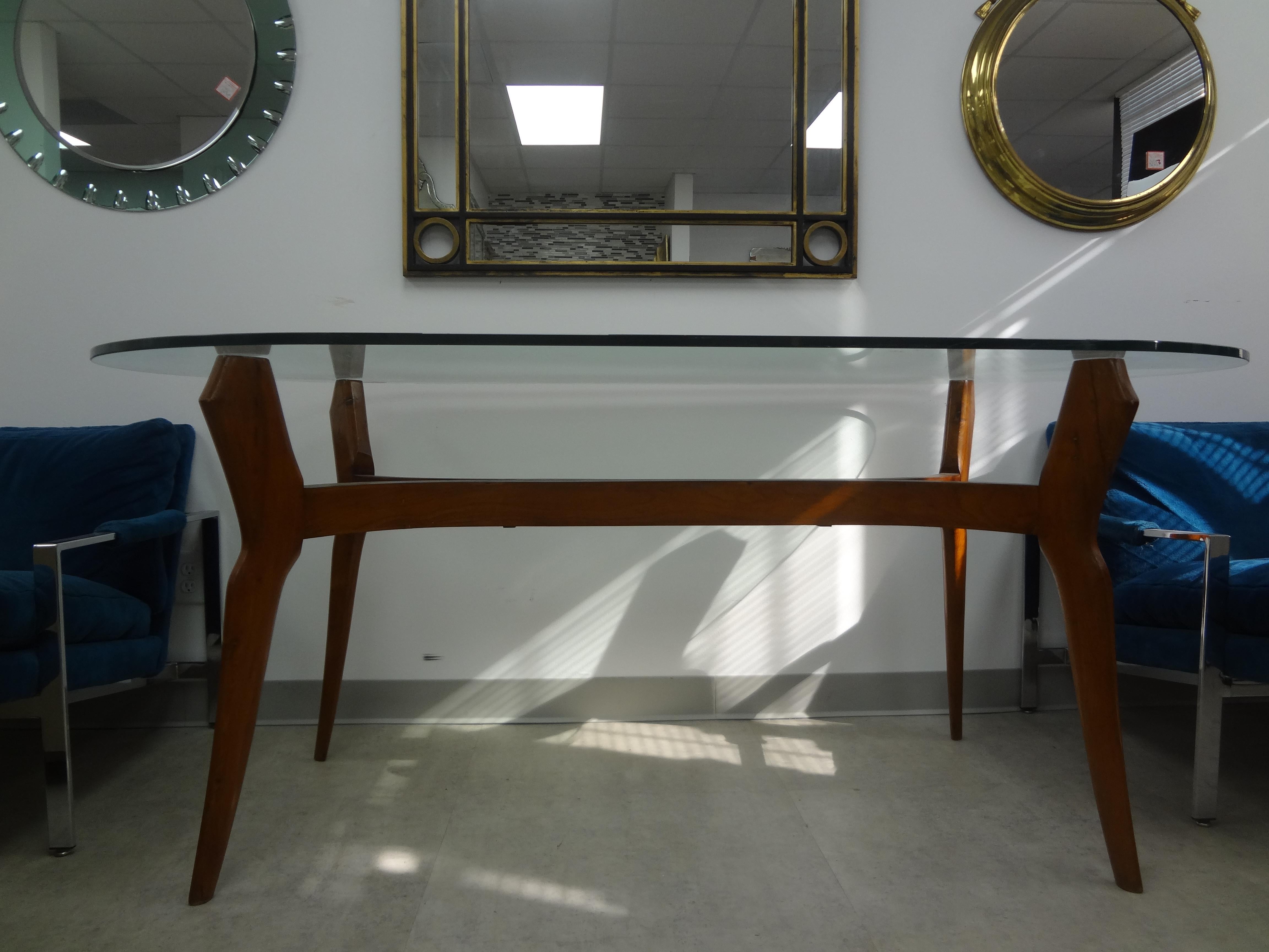 Italian Modern Sculptural Dining Table With Glass Top.
This stunning Gio Ponti inspired Italian mid century modern walnut table has beautiful lines and the original half inch oval glass top. Our versatile table can be used as a dining table, center