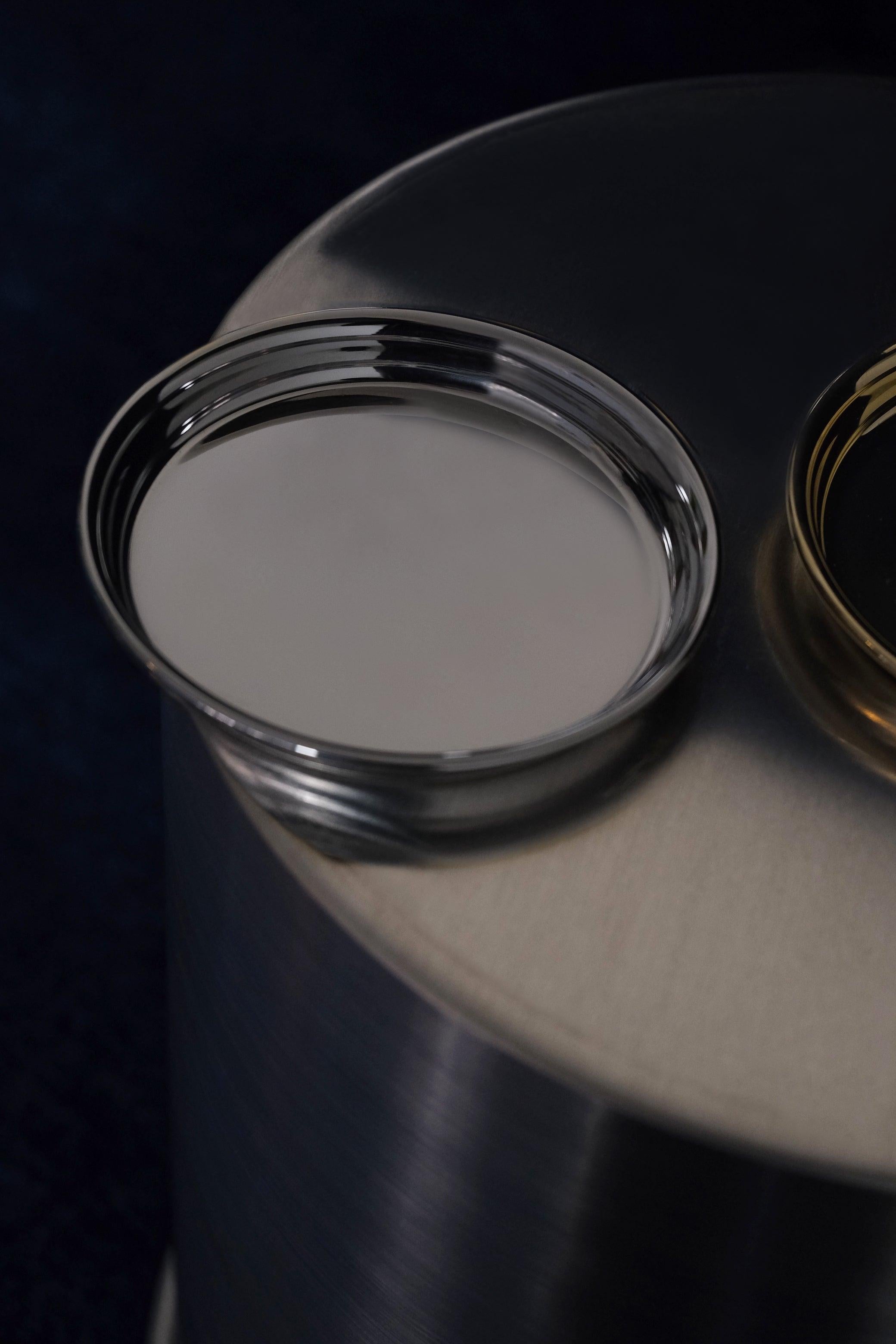 Crafted in polished Supermirror stainless steel, this set of 6 coasters or small multipurpose dishes blends contemporary elegance with functional design. Each piece features clean, essential lines accented by a signature rounded-edge detail from the