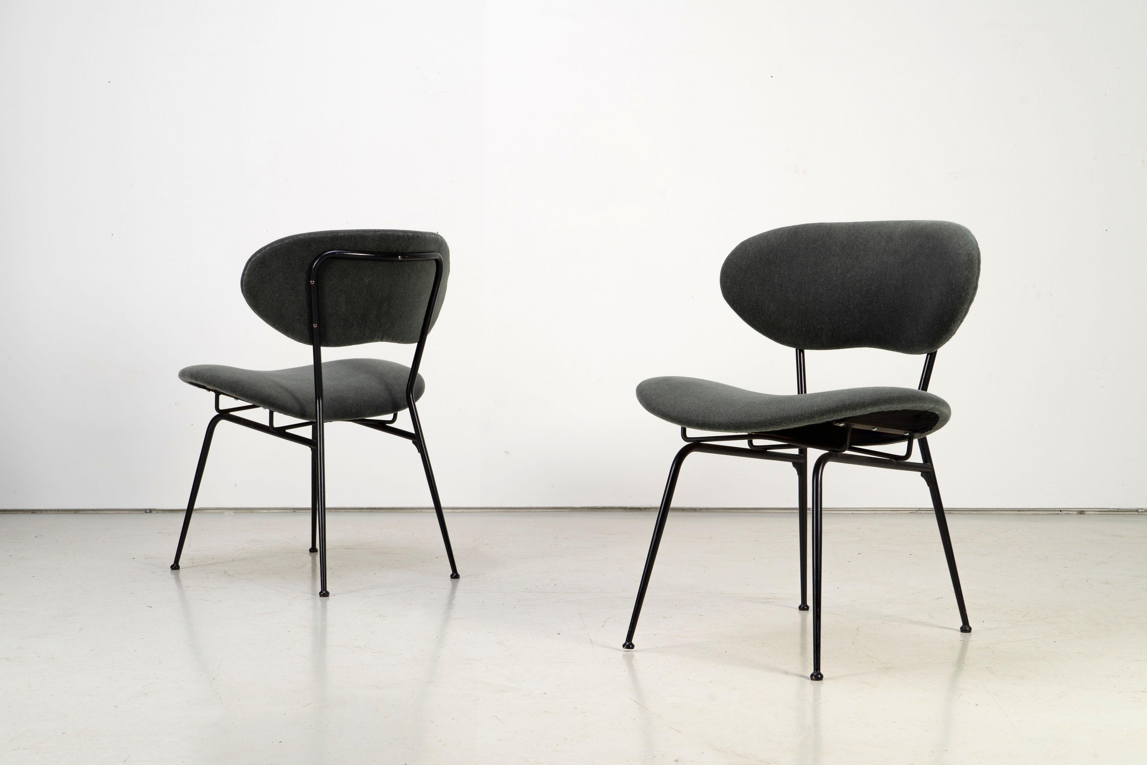 Set of two chairs with thin steel frames and upholstered seat and backrest. Upholstery has been reneewed with Mohair fabric (by Kvadrat).