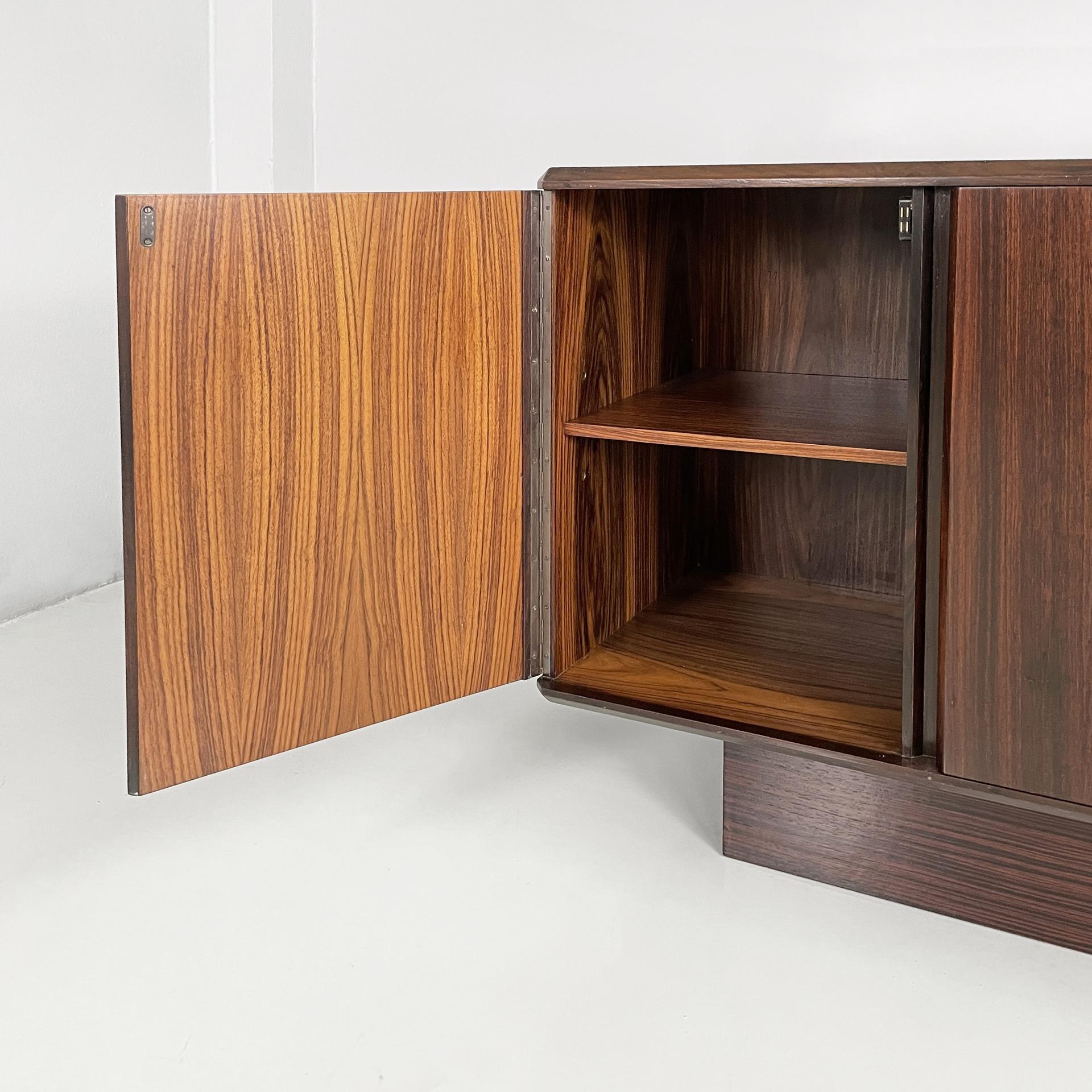 Late 20th Century Italian modern sideboard in wood with hinged doors, shelves and drawers, 1970s For Sale