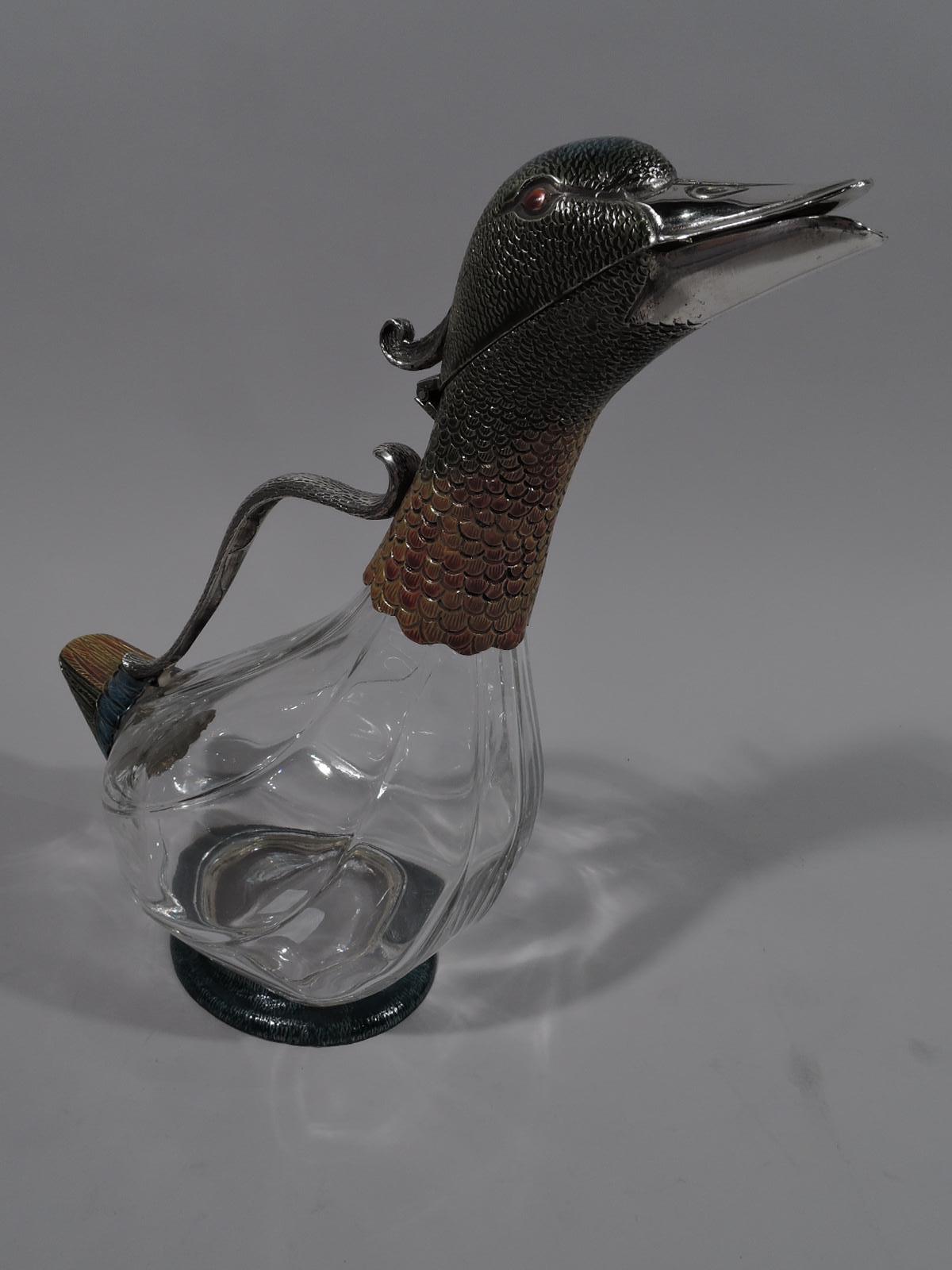 Modern glass and enameled sterling silver figural bird decanter. A duck with clear glass body. Head and neck enameled sterling silver with scaly and stippled feathers. Compact triangular tail and round foot. Head hinged for pouring. “Quack, quack”