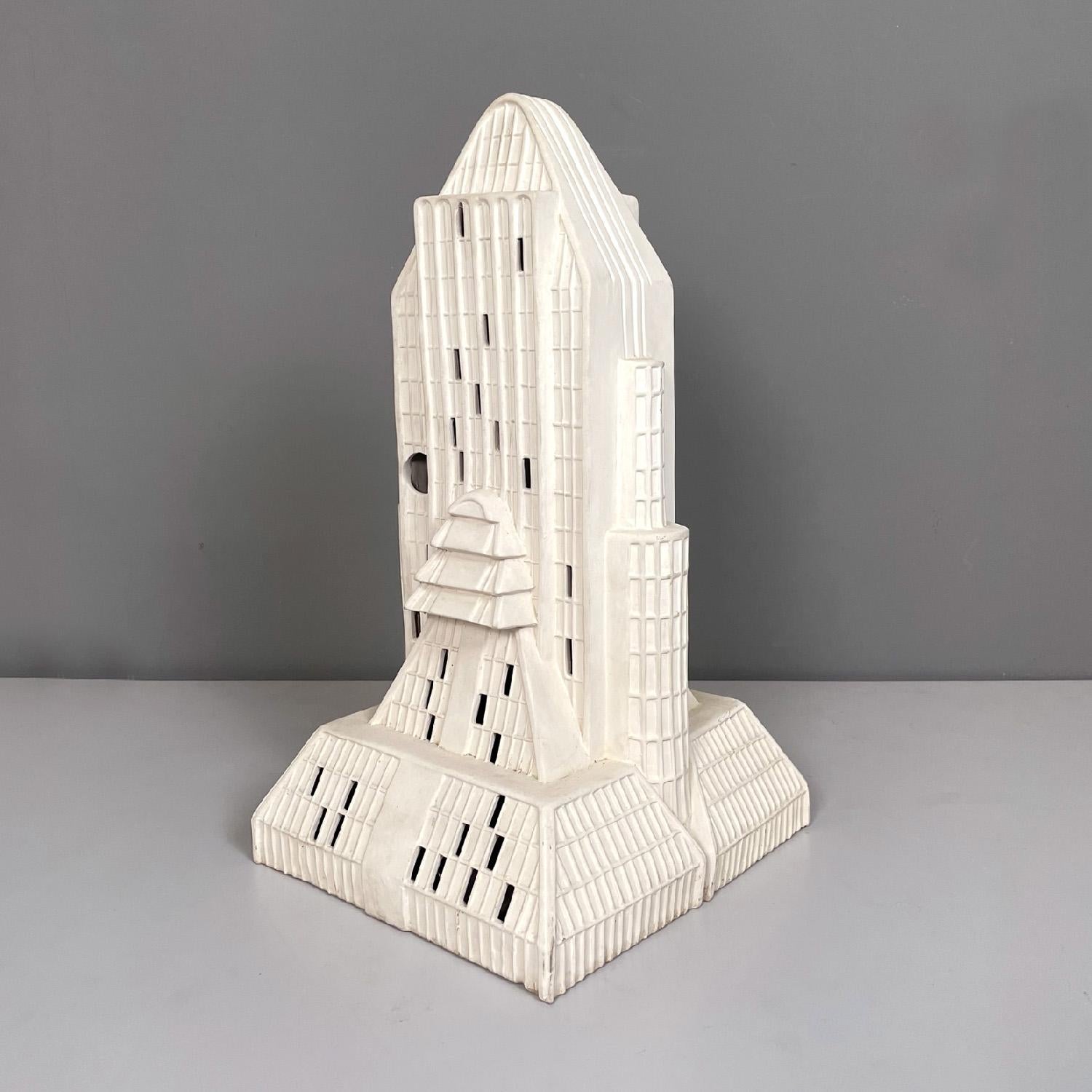 Italian modern skyscraper white beige Biscuit ceramic sculpture, 1980s
Sculpture with rectangular base in Biscuit ceramic. The sculpture represents a skyscraper, on one side there is a circular hole and small rectangular holes that correspond to the