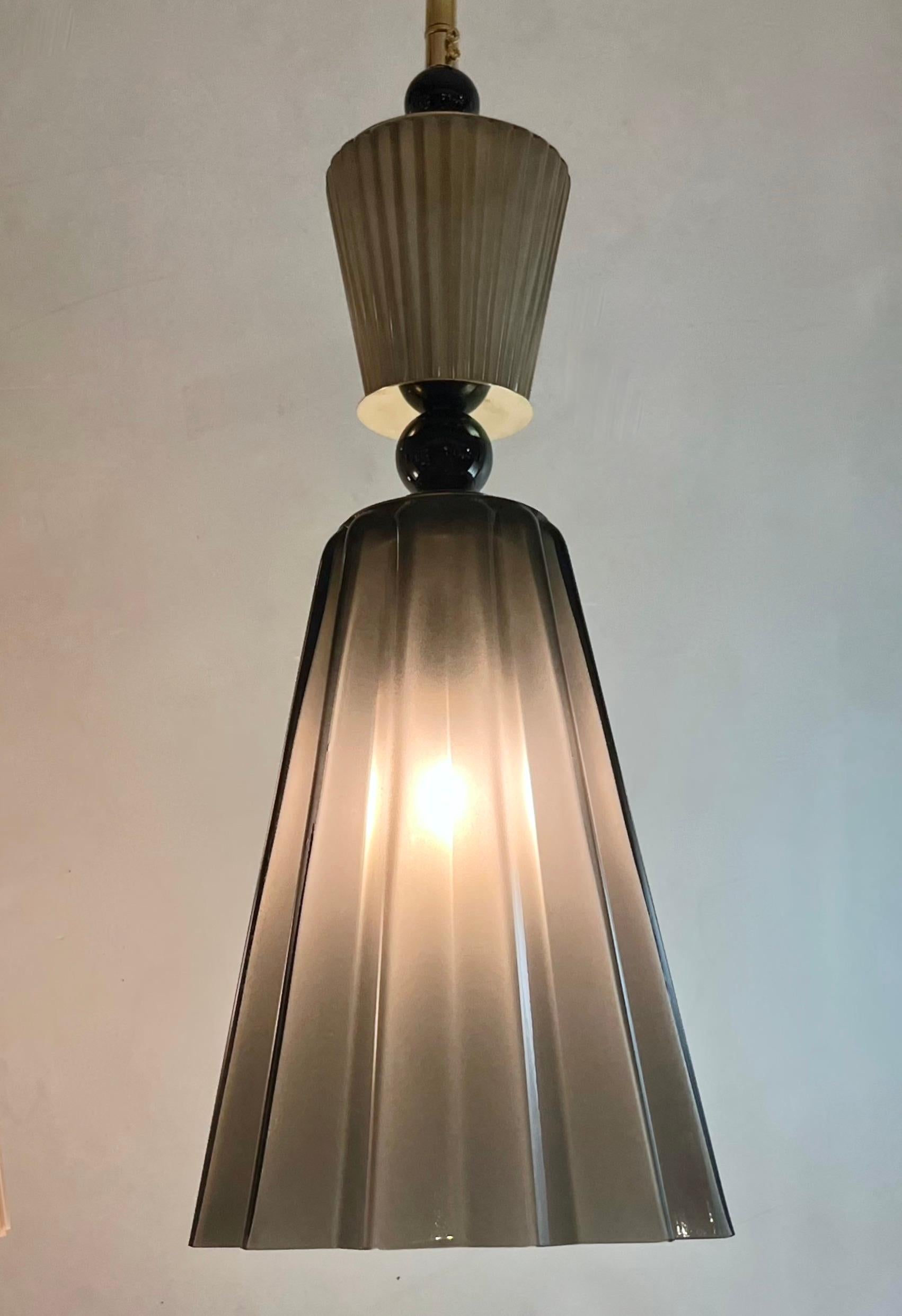 Pendant in opaline blown Murano glass of star shape, in smoked gray, also available in light pink, aqua-blue, decorated with a reeded glass cap accompanied with black glass spheres, fitted with a handmade triangular canopy. High quality of