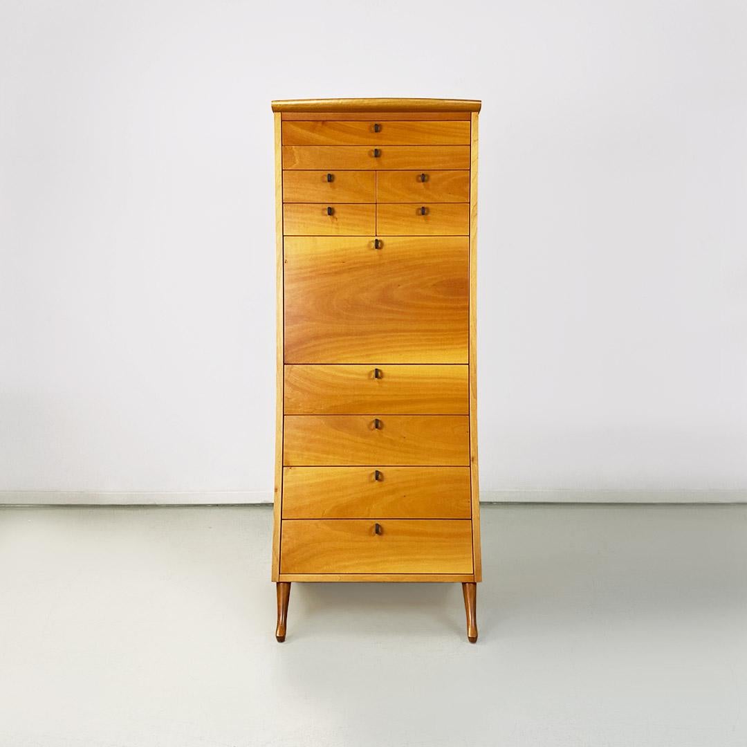 Italian modern solid wood chest of drawers by Umberto Asnago for Giorgetti, 1982.
Chest of drawers or high cantilevered secretaire with solid wood structure in light color, composed of ten drawers of various sizes, with ring handles, matt black