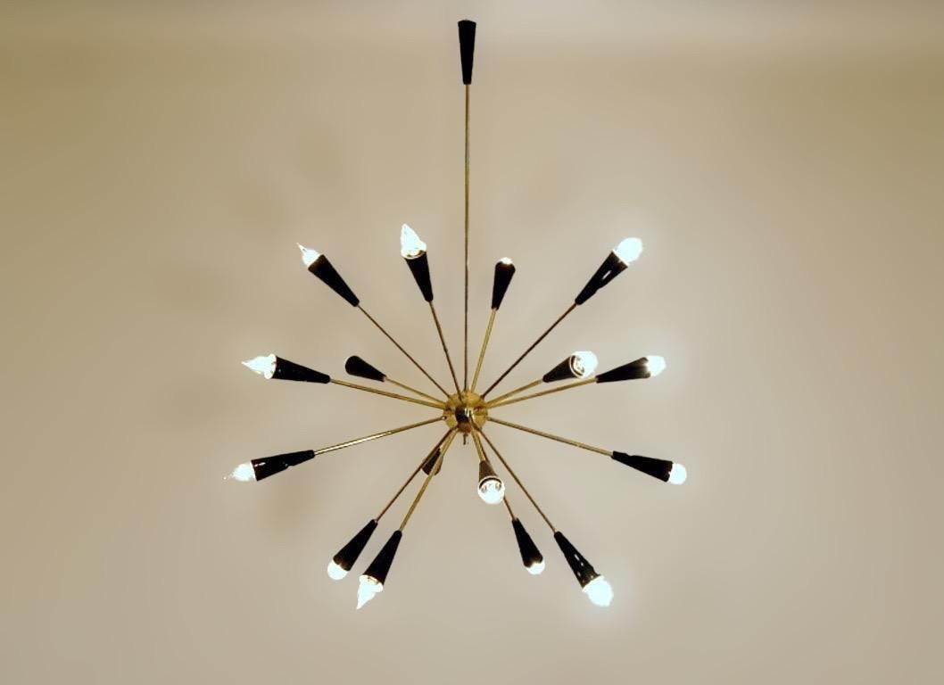 Wildly sculptural sputnik chandelier shown in un-lacquered natural brass with black enamel fabricated in Italy by Fabio Ltd. 

This is a modern, contemporary interpretation of a Classic Sputnik chandelier, strongly influenced by Italian Mid-Century