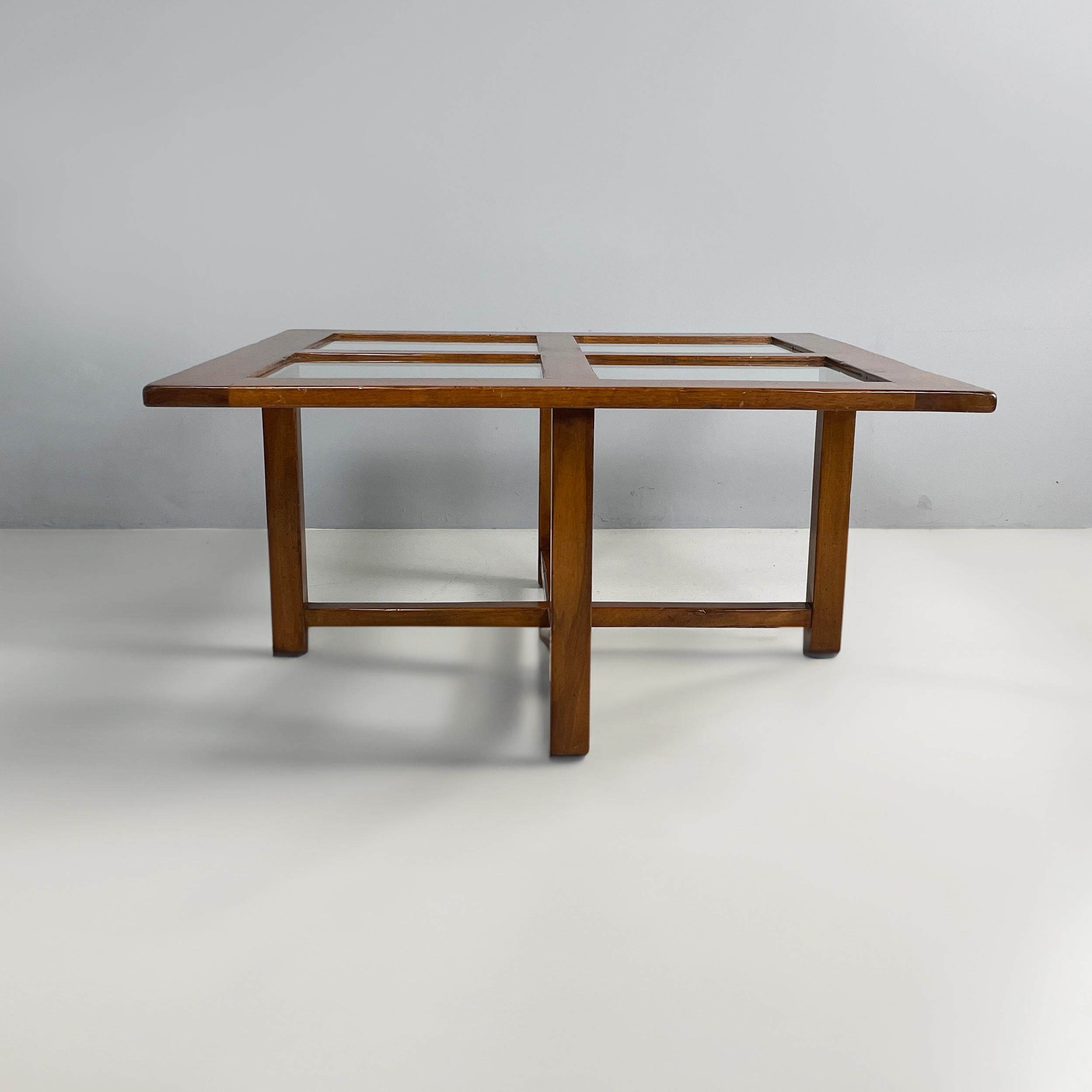 Italian modern Square coffee table in wood and glass, 1980s
Coffee table with square top with rounded corners, which is divided into 4 glass squares by wooden slats. The cross-shape base is made of wooden slats.
1980 approx.
Good conditions. Light