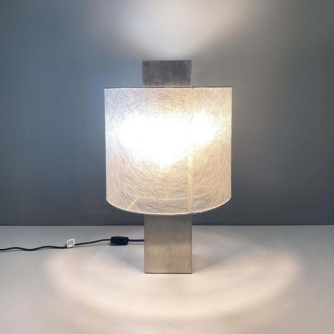 Italian modern chromed steel and semi transparent fabric lampshade table lamp by Pia Guidetti Crippa for Lumi, 1980s.
Table lamp or abat-jour with square base in chromed steel, with cylindrical lampshade, with semi-transparent finish with aluminum