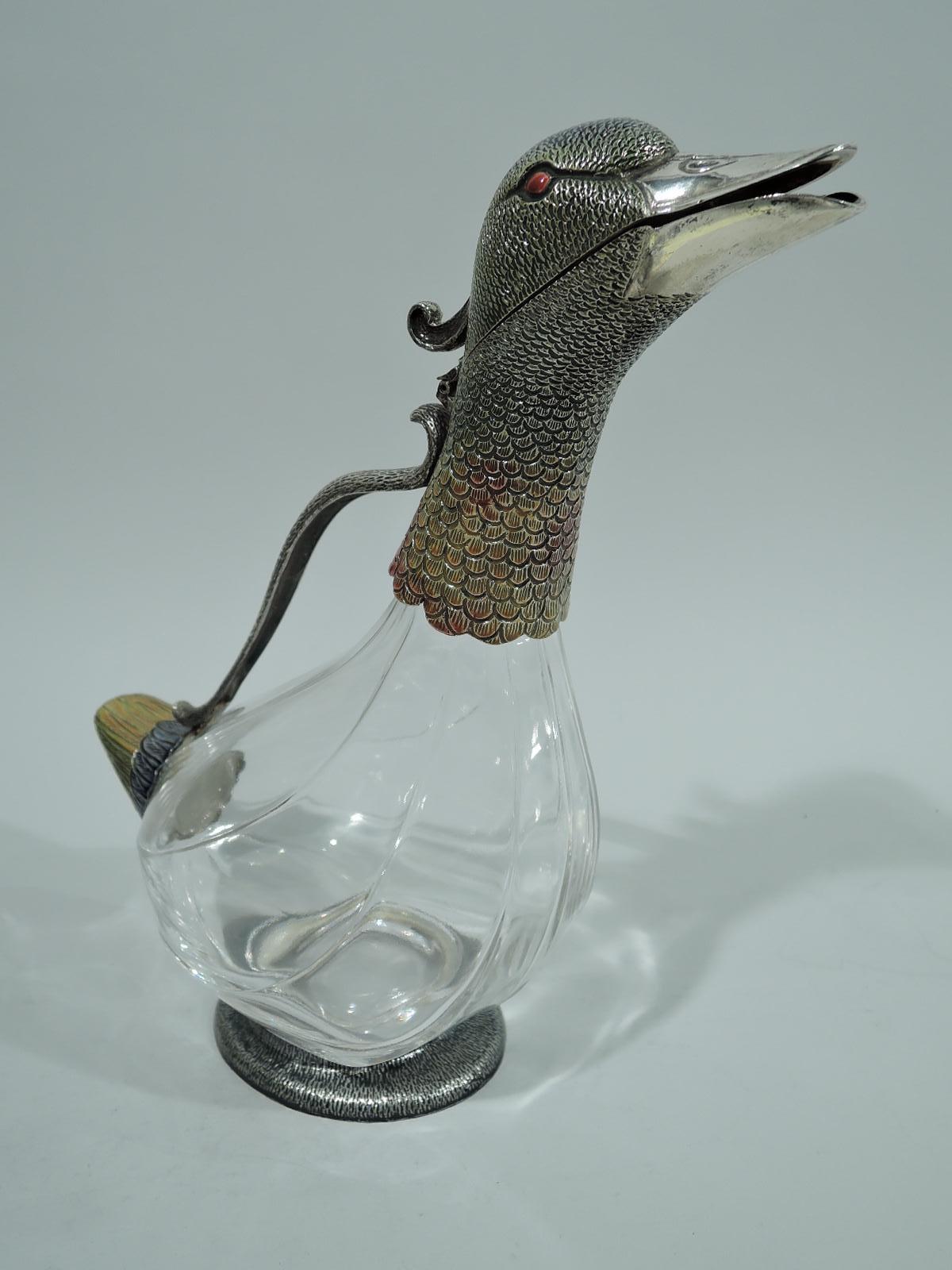 Modern glass and enameled sterling silver figural bird decanter. A duck with clear glass body. Head and neck enameled sterling silver with scaly and imbricated feathers. Compact triangular tail and oval base. Head hinged for pouring. “Quack, quack”