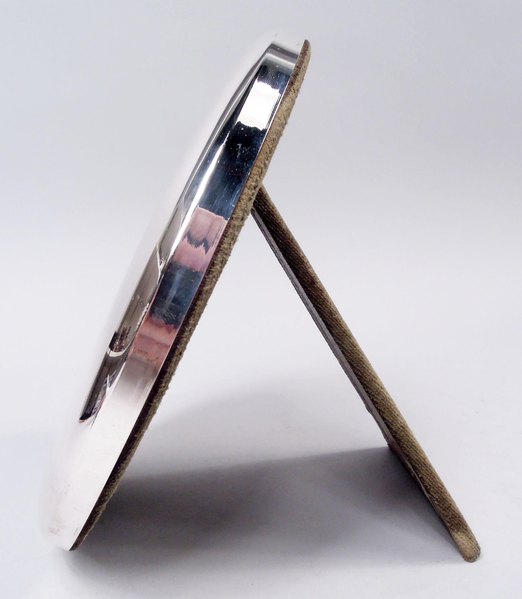 Modern sterling silver frame. Surround has round and curved front and flat sides. With glass, silk lining, and velvet back and hinged easel support. Post-1967 Italian marks including maker’s stamp (Bartolini Bartolozzi).  
Diameter: Surround: H 7