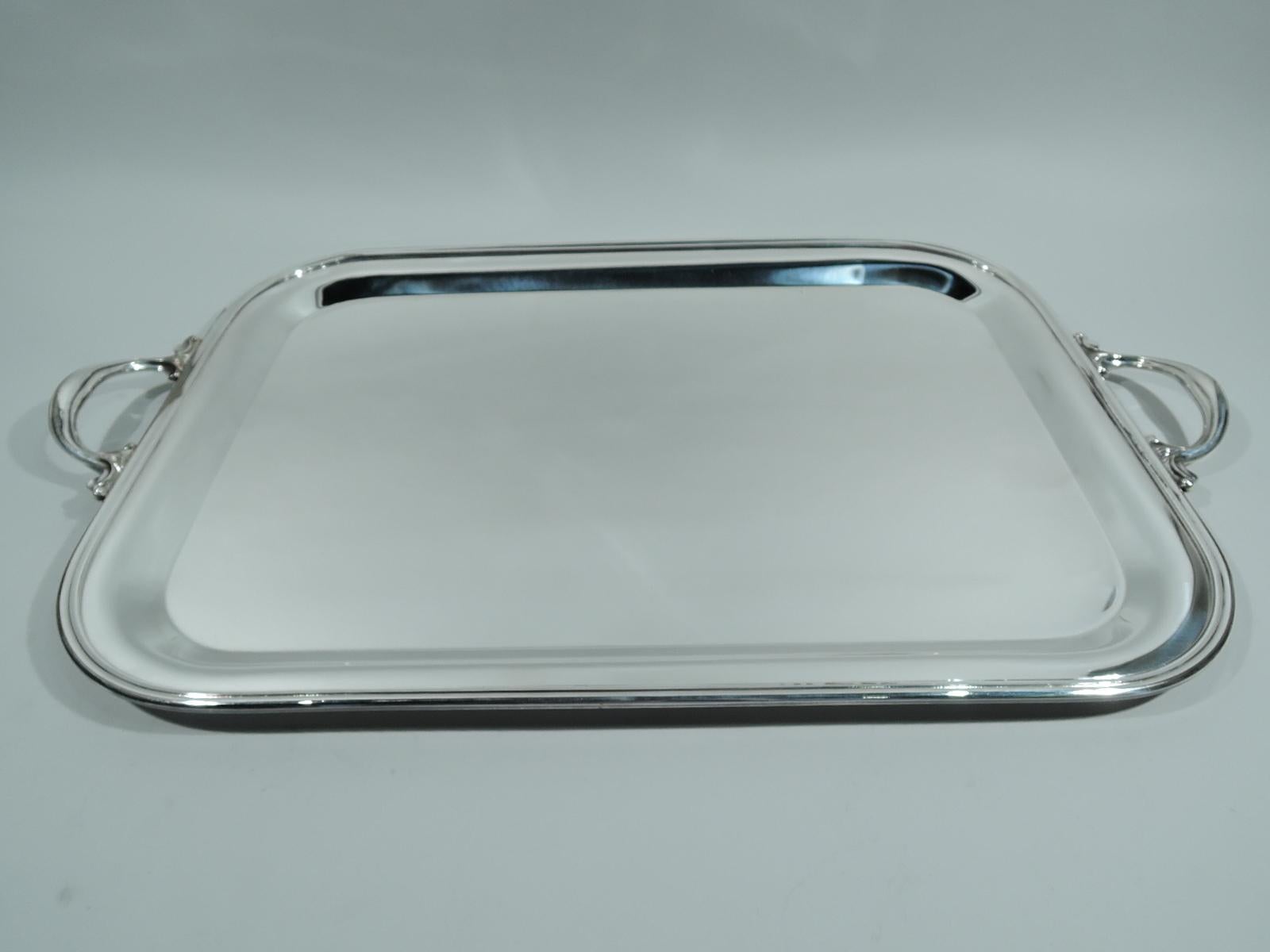 Modern sterling silver serving tray. Rectangular with curved corners and molded rim. Leafy-scroll mounted c-scroll end handles. Post-1967 Italian marks including Pampaloni maker’s stamp. Weight: 111 troy ounces.