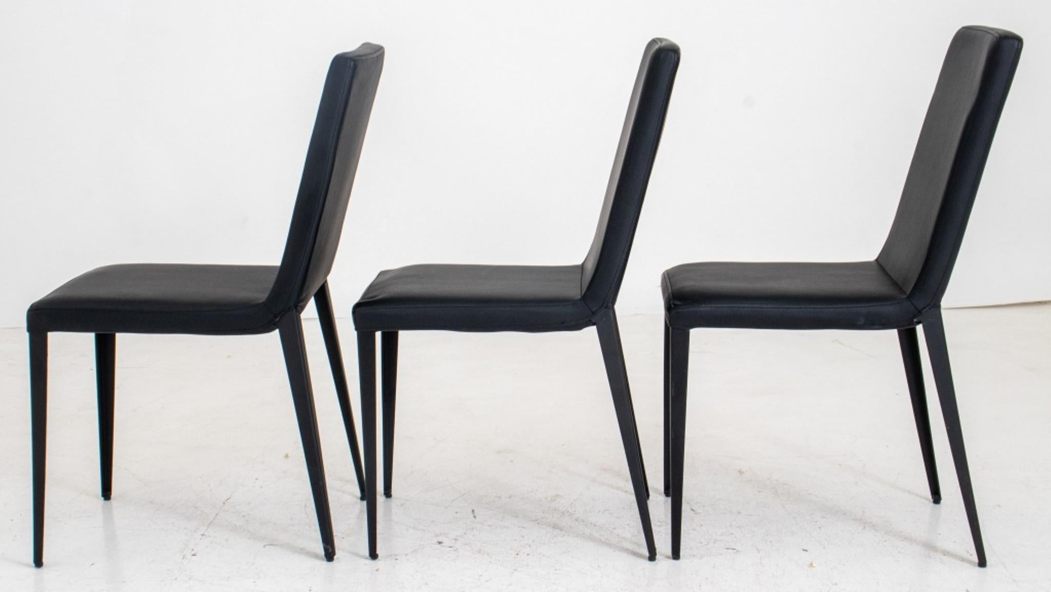 Italian Modern style black dining or side chairs, the three with rectangular back and conjoined seat in leather on tapering columnar legs. In very good vintage condition. 

Dealer: S138XX 