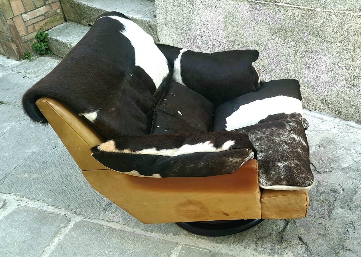 Vintage, Mid-Century, Italian swivel leather and cow hide chair.
 Ottoman is also swivel and is original condition. Ottoman measurement 23x23 height 15.
   