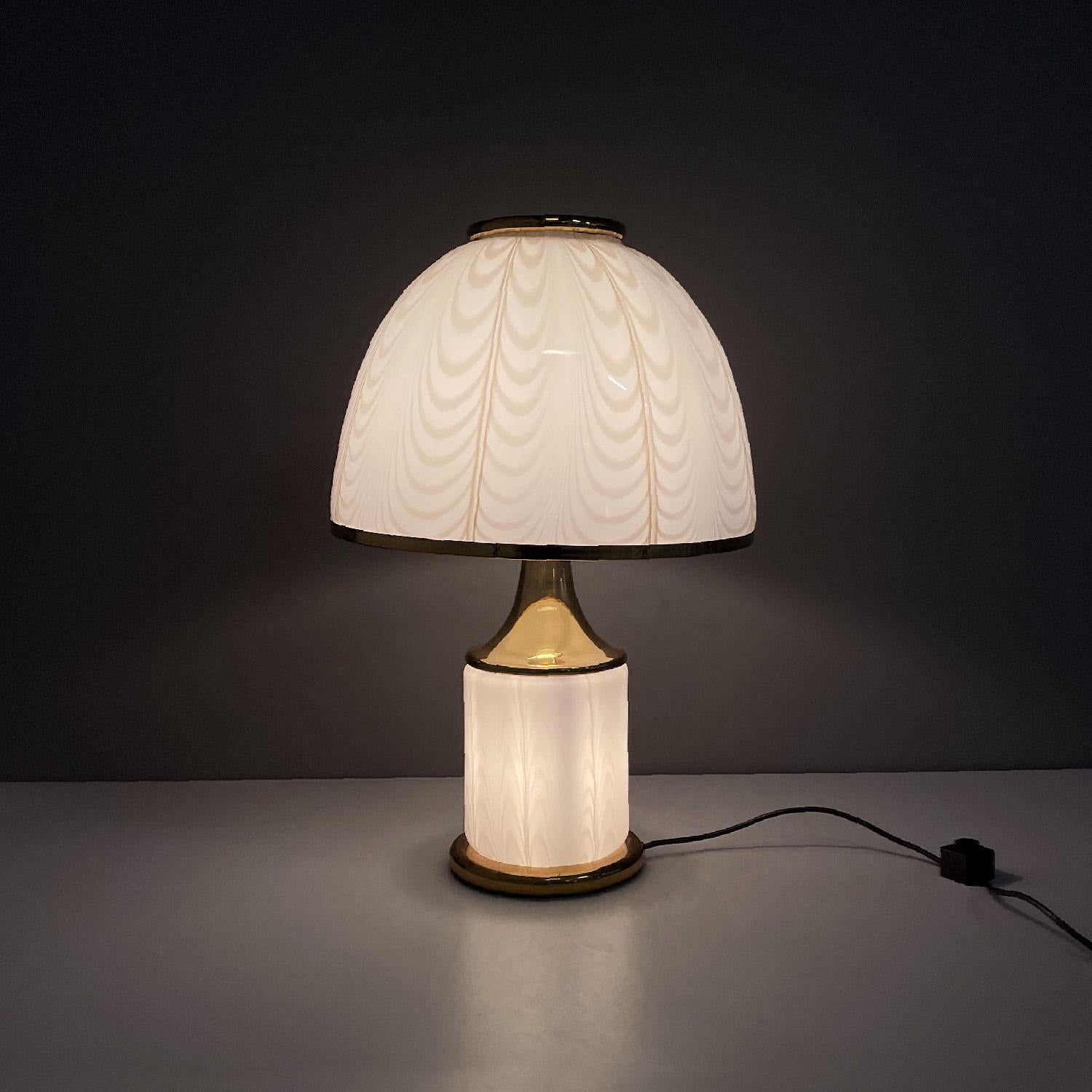 Italian modern table lamp in Murano glass by Fabbian Illuminazione, 1980s
Round base table lamp. The lamp is composed of a cylindrical structure in opaline Murano glass with a slightly raised texture of light yellow color, the same finish and