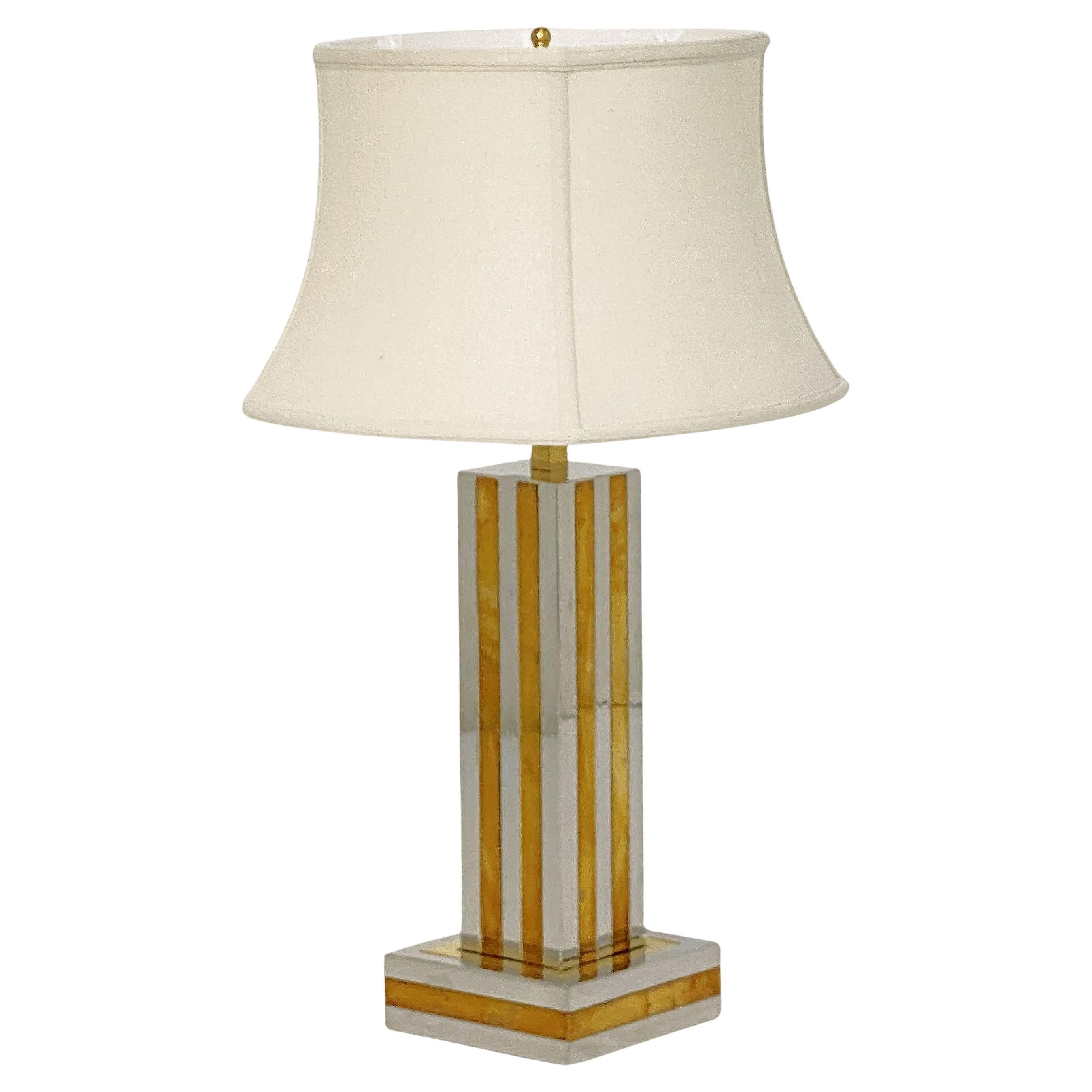 A fine Italian Modern table lamp of chrome and brass by the celebrated designer, Romeo Rega, featuring an elegant column post design set upon a square base. With shade and U.S. wired.