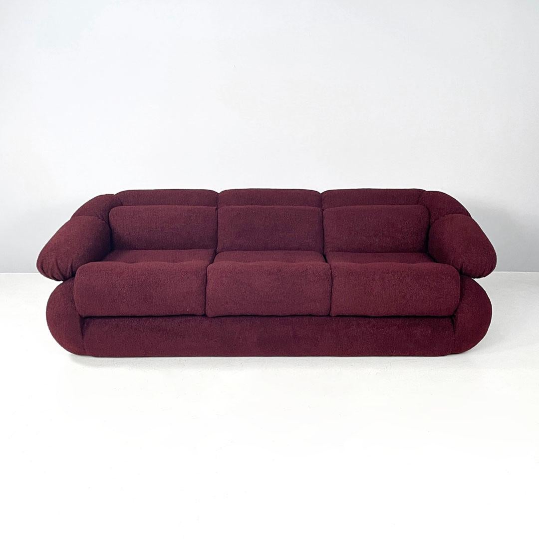Italian modern three-seat sofa in burgundy teddy fabric, 1970s
Three-seat sofa in burgundy Teddy fabric. It features soft and curved lines, from the backrest, to the seat and armrests. With three cushions corresponding to the three seats in front of