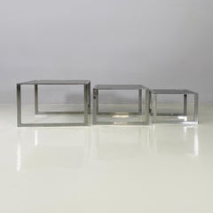 Italian modern Trio of coffee tables in smoked glass and metal, 1980s