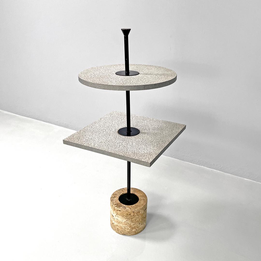 Italian modern two laminate tops coffee table with travertine base, 1980s
Round base coffee table. It has two laminate shelves decorated with a pattern composed of small elements in shades of gray, the upper shelf is round while the lower one is