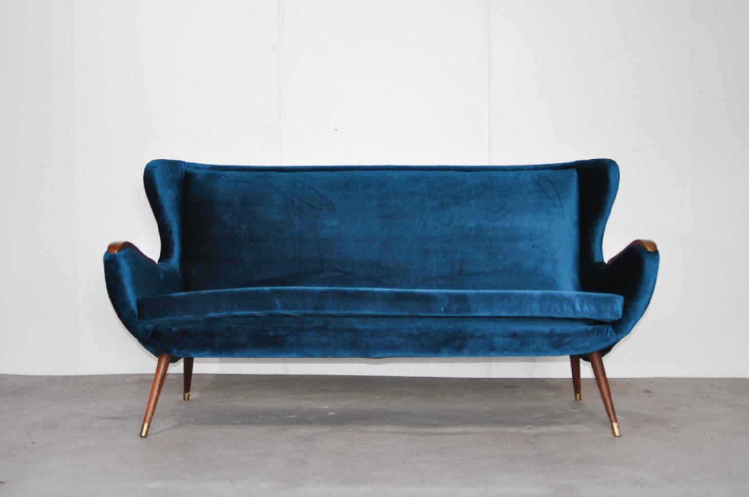 Vintage velvet petrol sofa, Italy, 1960s

Re-upholstered in petrol colored velvet. With wooden arm-rests and legs and brass details.

Measures: Length 170 cm; seating 145 cm
Depth 80 cm; seating 55 cm
Height 85 cm; seating 44 cm.