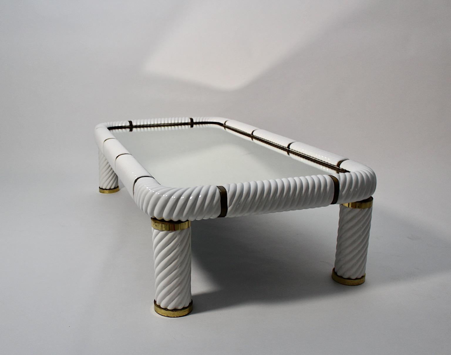 Italian Modern vintage sofa table or coffee table from white ceramic and solid brass by Tommaso Barbi 1970s Italy.
A sophisticated handmade and high quality sofa table by Tommaso Barbi 1970s Italy from white curled glazed glossy ceramic and solid
