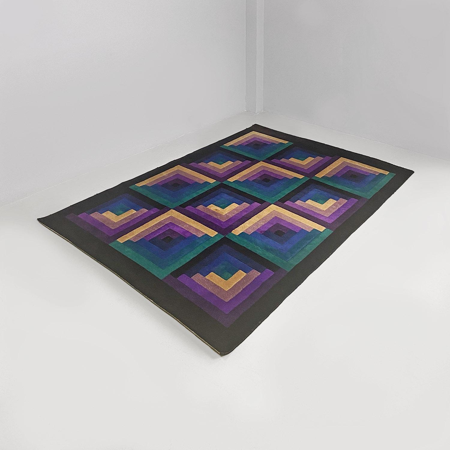Italian modern colored virgin wool carpet with geometric pattern by Missoni for T&J Vestor, produced in 1980s.
Rectangular carpet, in virgin wool, with a geometric pattern in different colors in shades of blue, green, purple and beige, with a black