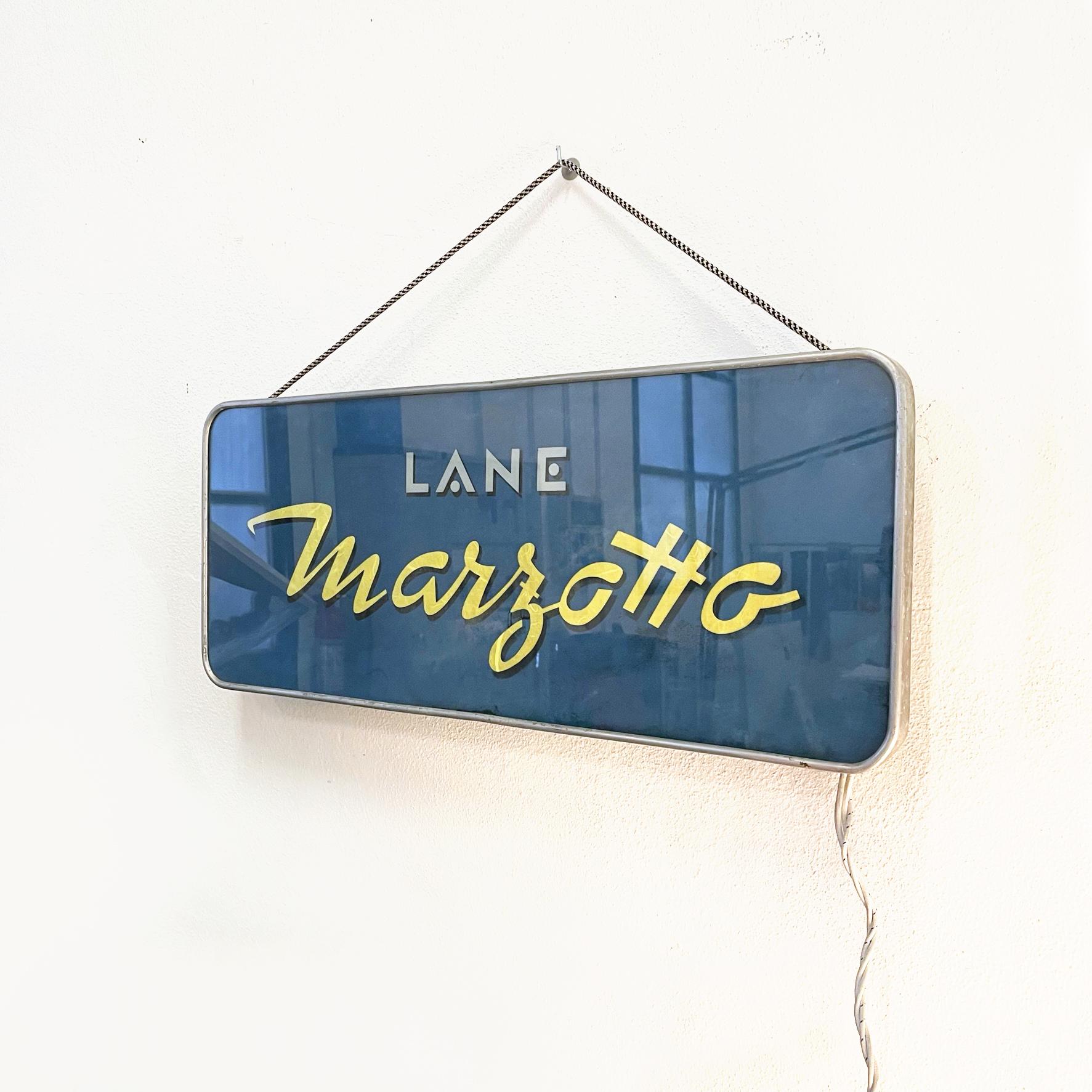 Italian modern Wall light sign by Lane Marzotto in plastic and metal, 1990s
Rectangular wall light sign with rounded corners. On the central plastic panel there is the writing Lane Marzotto in gray and yellow on a blue background, which is backlit.