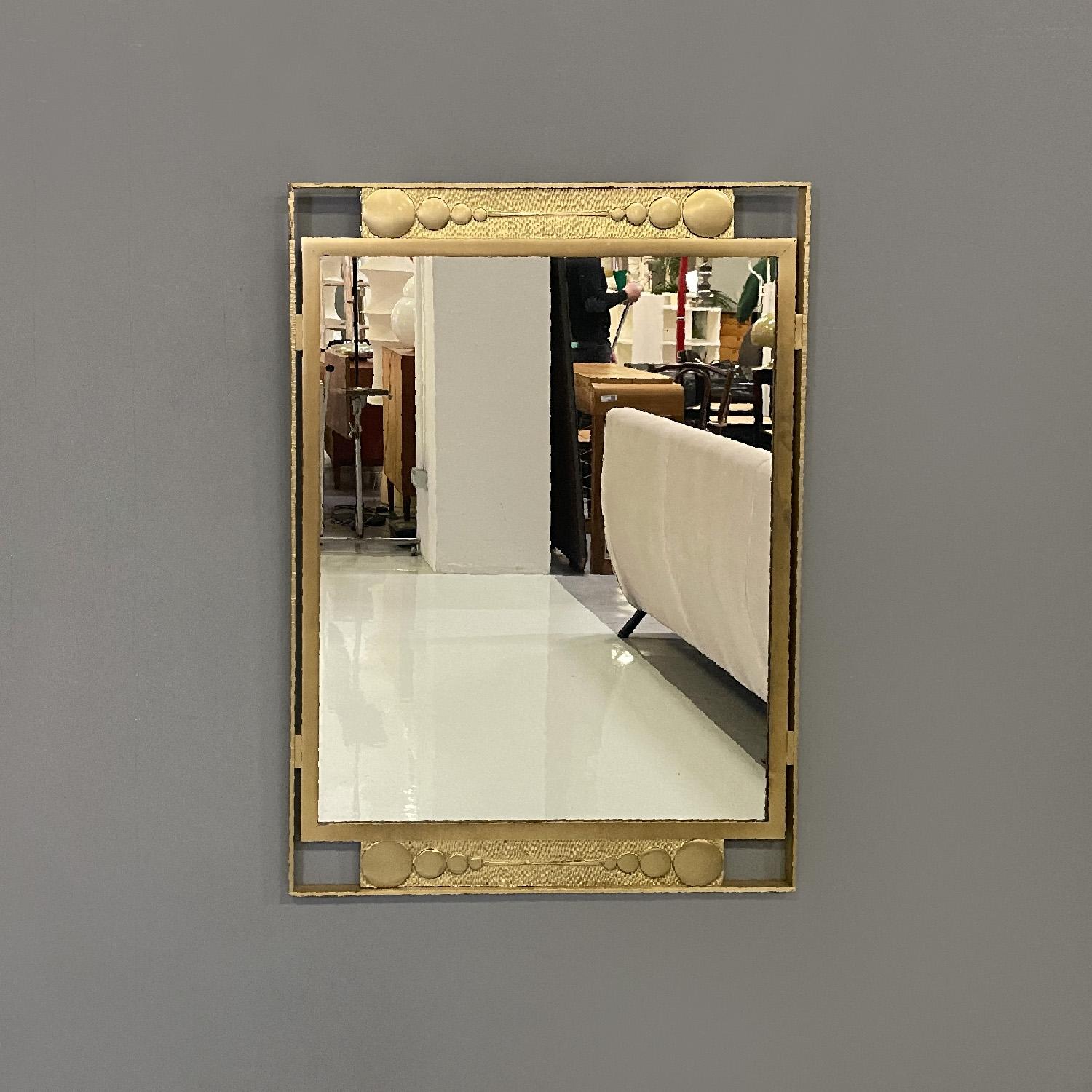 Italian modern wall mirror in golden metal with geometric decorations, 1980s
Rectangular wall mirror. It features a gold metal frame with geometric decorations in the upper and lower central parts of the frame.
1980s.
Good condition, it has