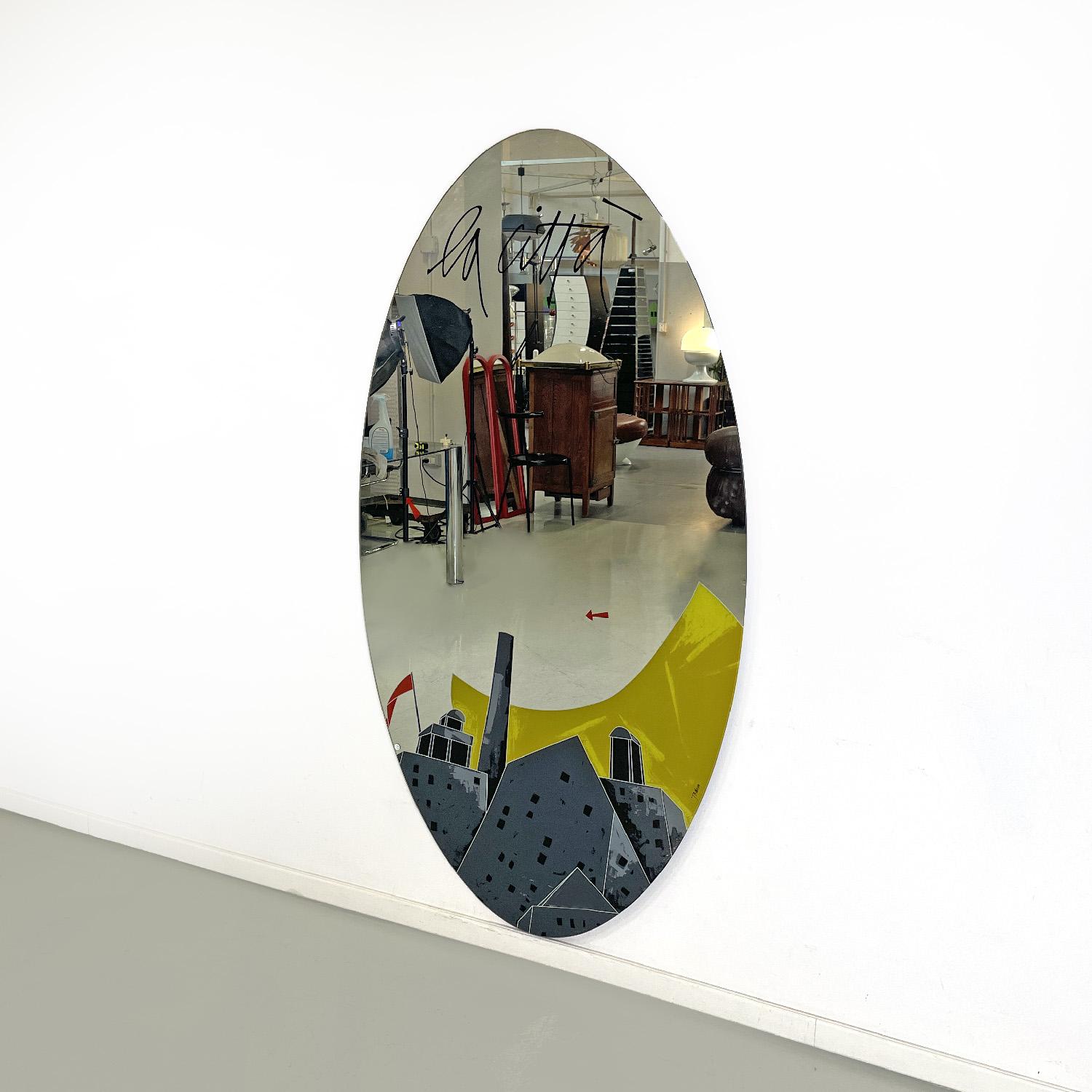 Italian modern wall mirror La Città by Emilio Tadini for Rimadesio, 1983
Oval wall wooden mirror, mirrored and silk-screened glass. At the bottom, the mirror features an illustration of a city with historic buildings in greyscale, a stylized