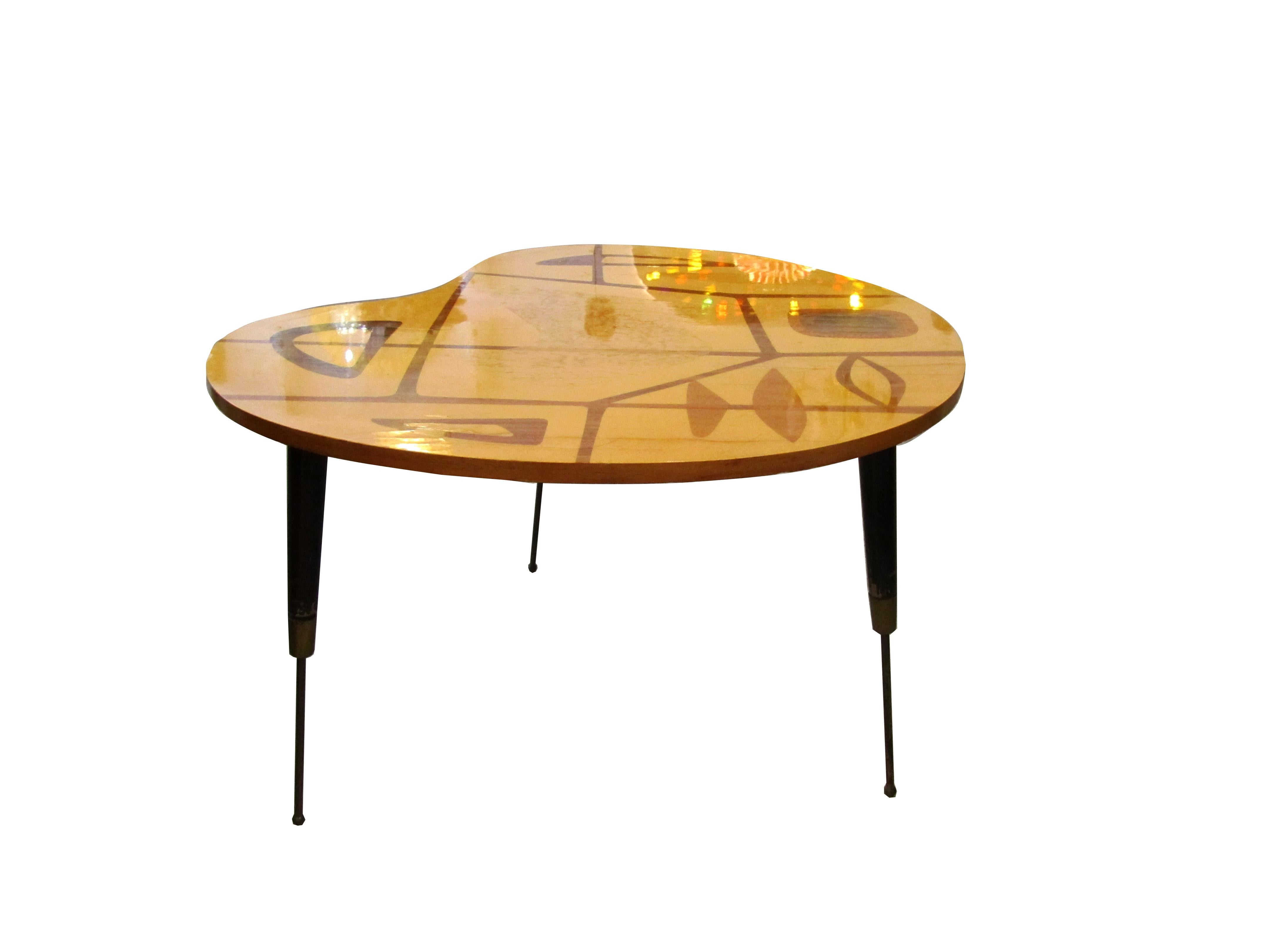 An Italian side table of exotic woods with 3 wooden legs tapering down to a brass cap and slim ball foot. The table top has a slight kidney shape to it. Beautiful inlays throughout.