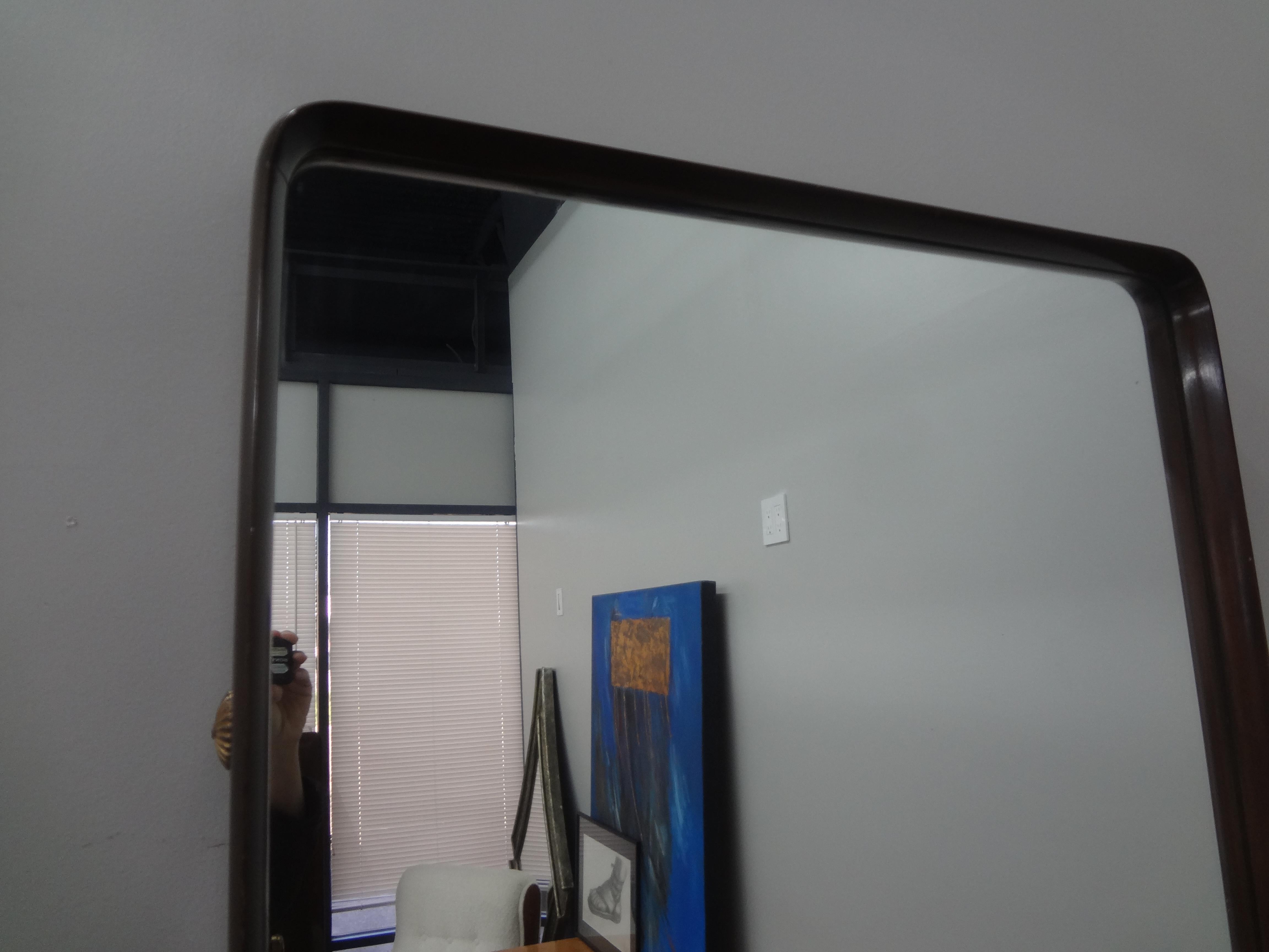 Italian Modern walnut mirror inspired by Ico Parisi.
This handsome Italian modern mirror, full length mirror or floor mirror is beautifully crafted of Italian walnut in a three dimensional design. The mirror is set inside the frame 1.5 inches with