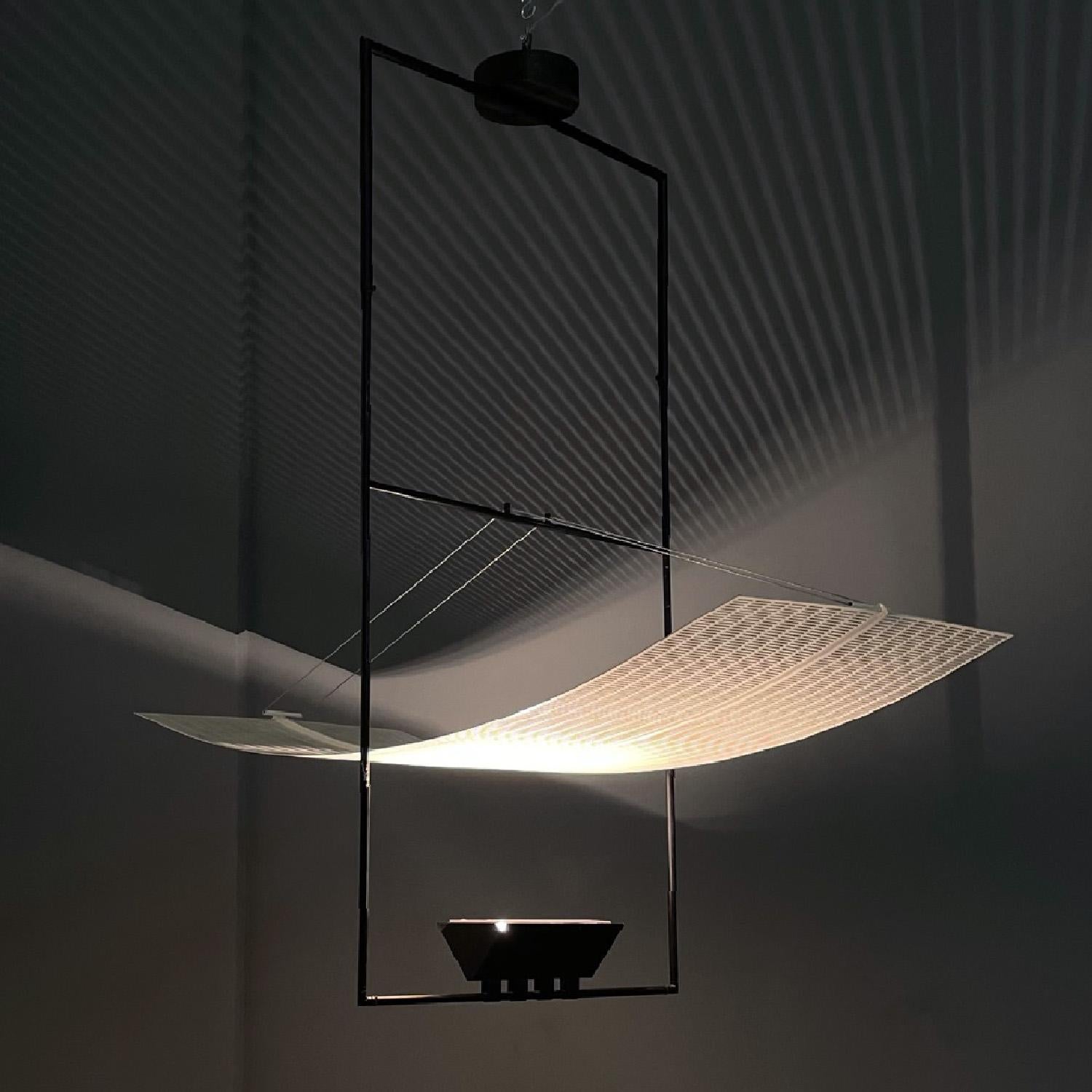 Italian modern white black chandelier Zefiro by Mario Botta for Artemide, 1990s
Chandelier mod. Zefiro with black metal rod structure in the center of which a curved perforated and white enamelled metal sheet is suspended by wires. Below this sheet