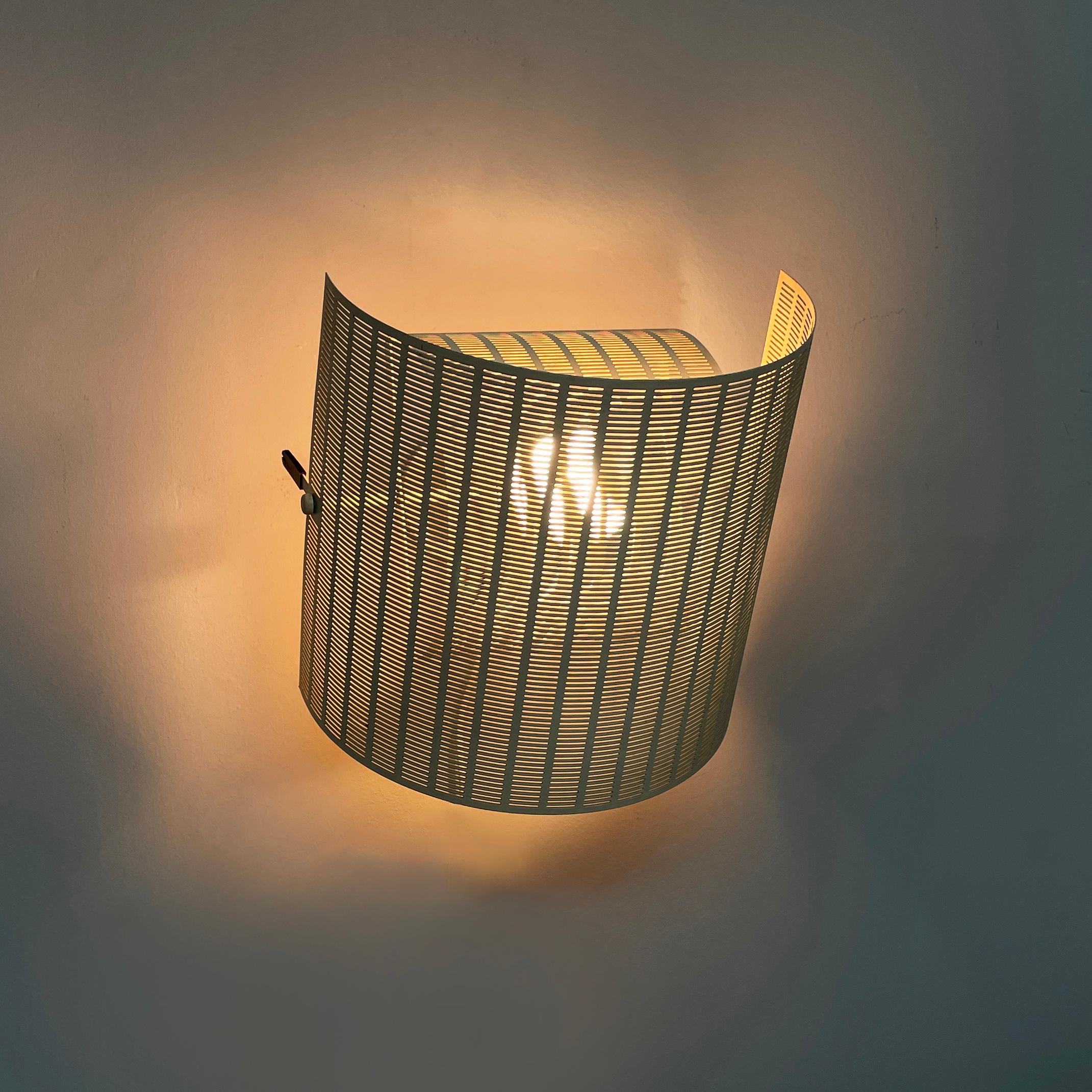 Italian modern white metal wall lamp Shogun by Mario Botta for Artemide, 1980s
Wall lamp model Shogun made entirely of metal. The lamp has a double adjustable diffuser made of curved, perforated and white-beige painted metal sheet. There are two