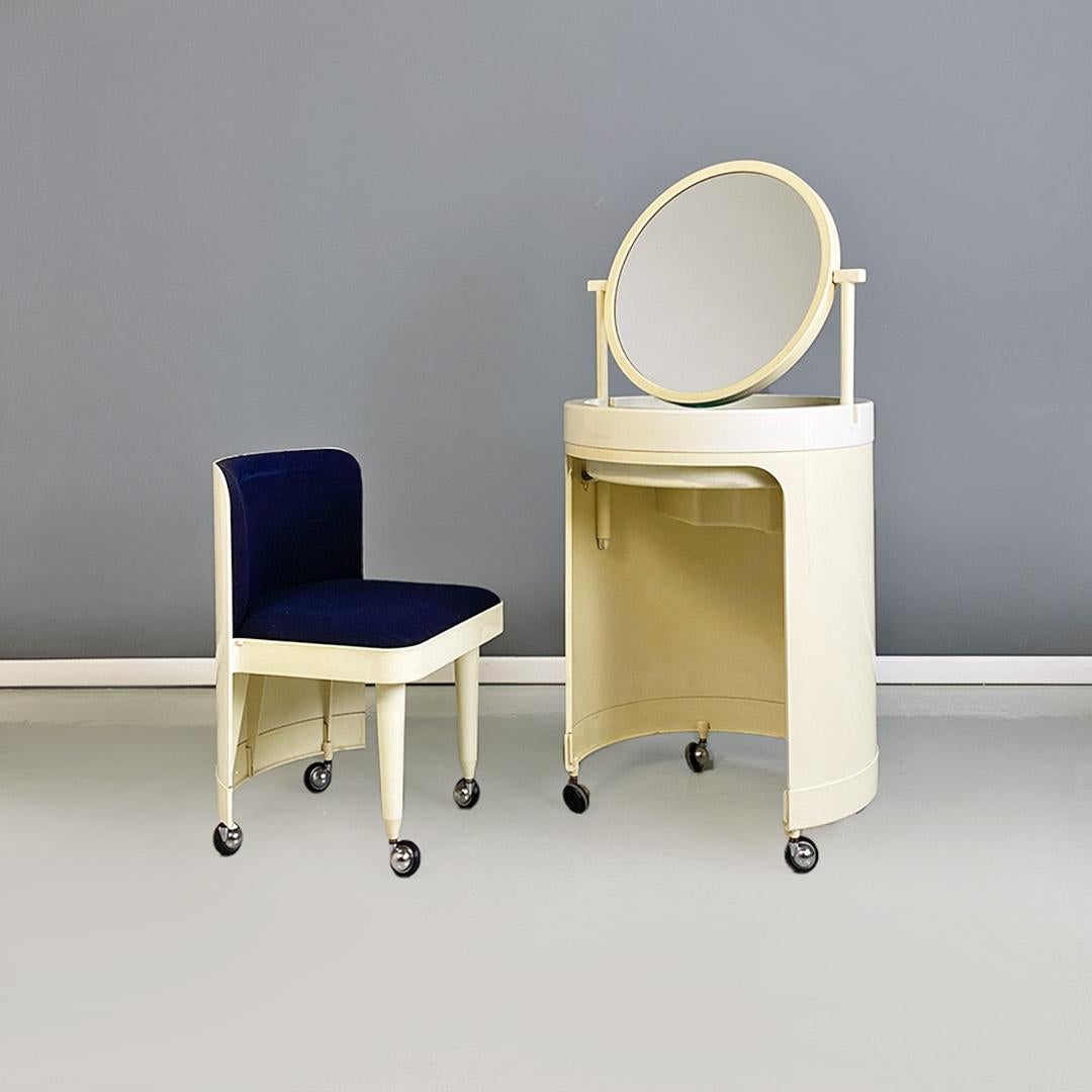 Make-up dressing table mod. Silvi, produced by Studio Kastilia during 1980s. Structure on wheels with cylindrical plastic part, with round top that can be modified into a mirror, locking and tilting mechanism, with internal container in blue