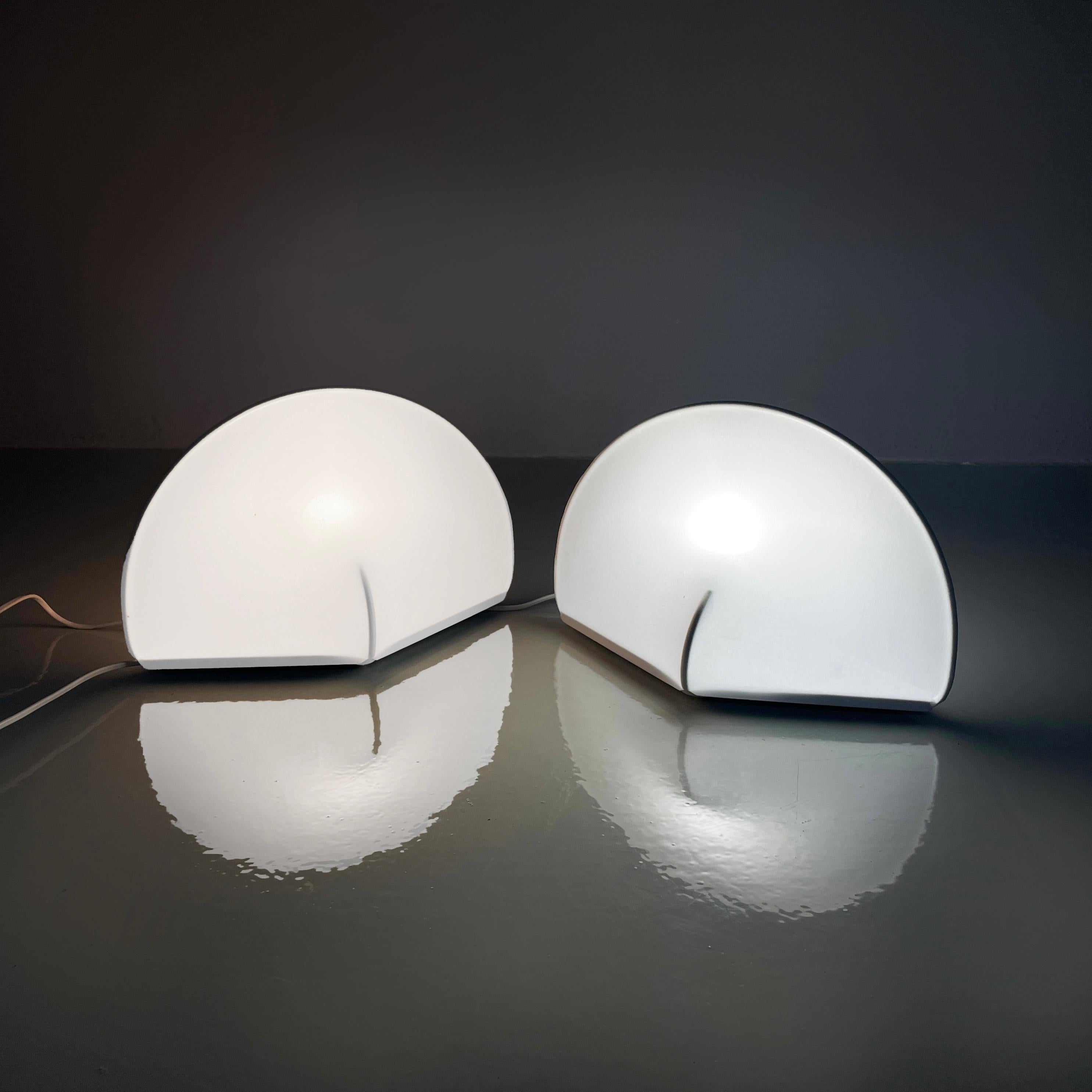 Italian modern white table lamps Kaori 1 by Kazuhide Takahama for Sirrah, 1970s
Pair of table lamps model Kaori 1 with rhomboid base in white metal. The structure is composed by a metal arch. The lampshade is made of white stretch jersey fabric,