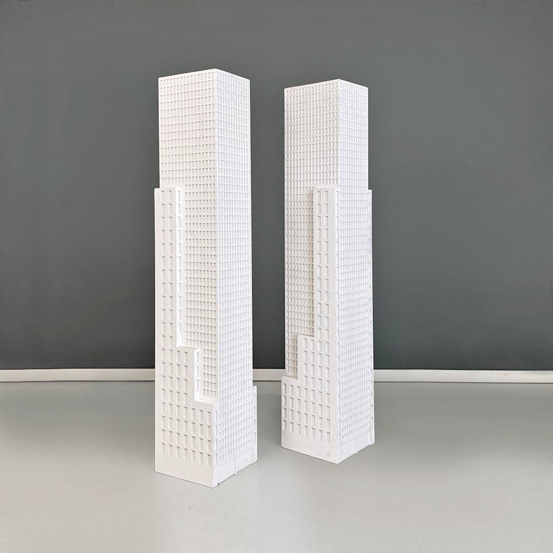 Italian modern white wooden skyscraper pedestals or display stands produced in the 2000s.
Pair of exhibitors or pedestals, with mdf structure, in the shape of a skyscraper, with a square base. Can be used both side by side in specular positions and