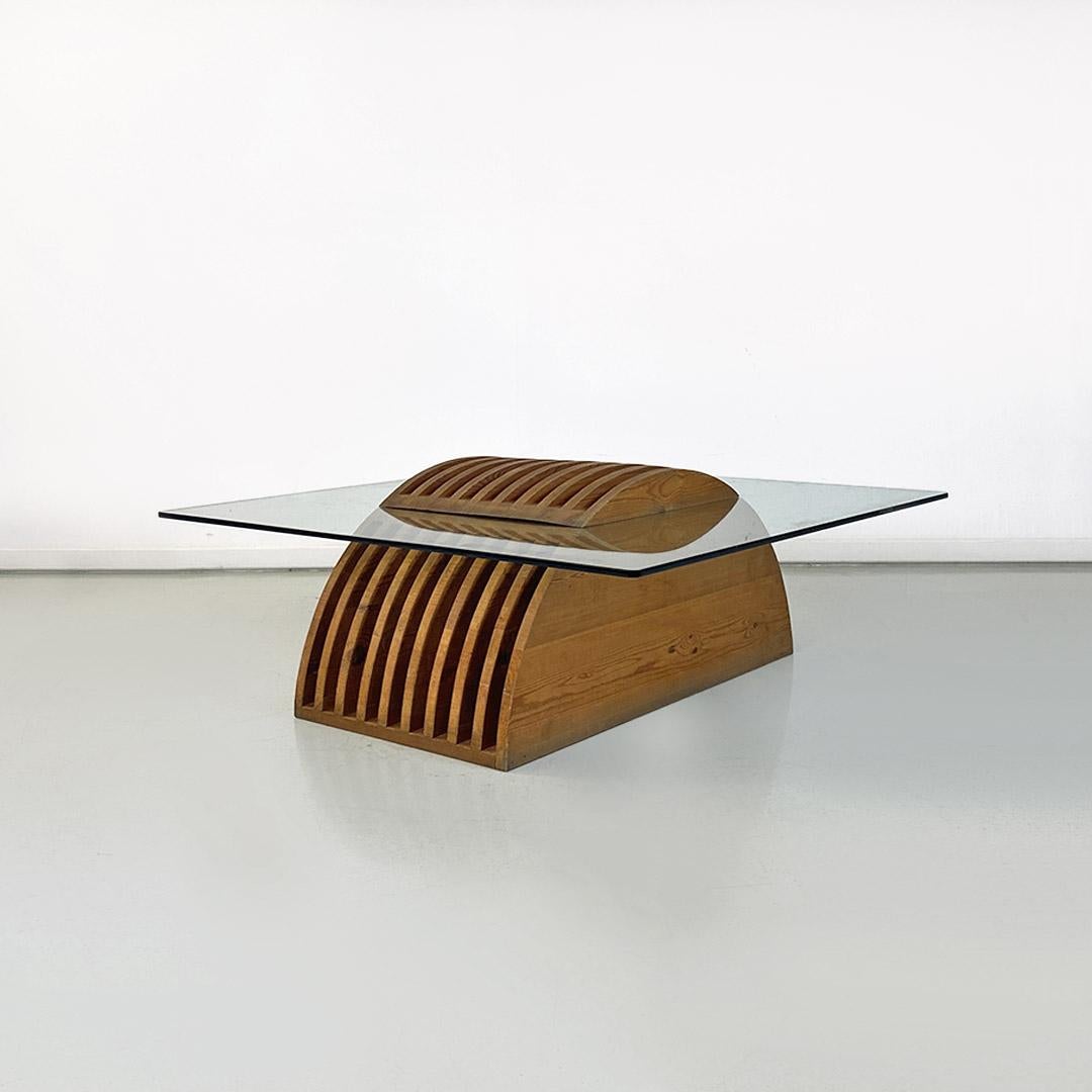 Italian modern solid wood base and glass top coffee table by Mario Ceroli for Poltronova, 1970s
Coffee table with hemispherical base, in solid wood, with grooves, divided into two parts, between which the glass top intersects, square in shape with