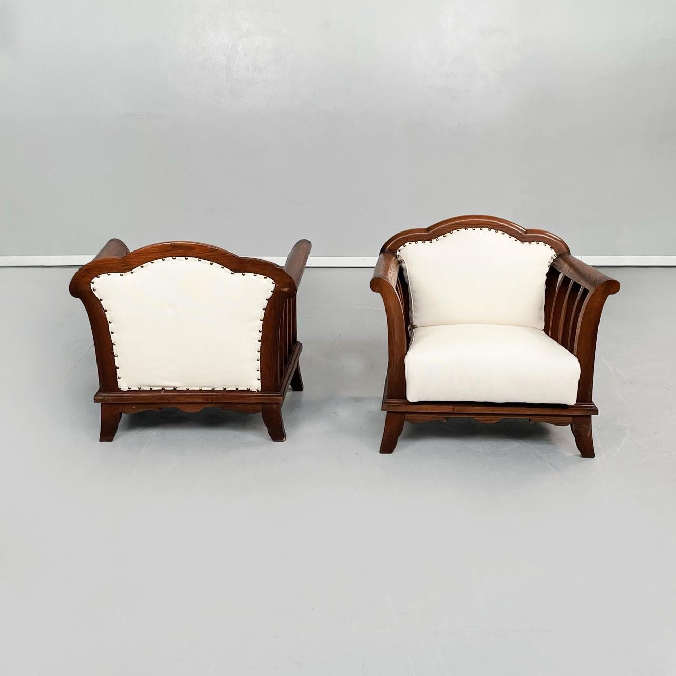 Italian modern wooden armchairs with white fabric, 1940s
Set of 2 armchairs with wooden structure. The armchair has a square seat and a square backrest with 3 semicircles on the top, both padded and upholstered in white fabric with exposed