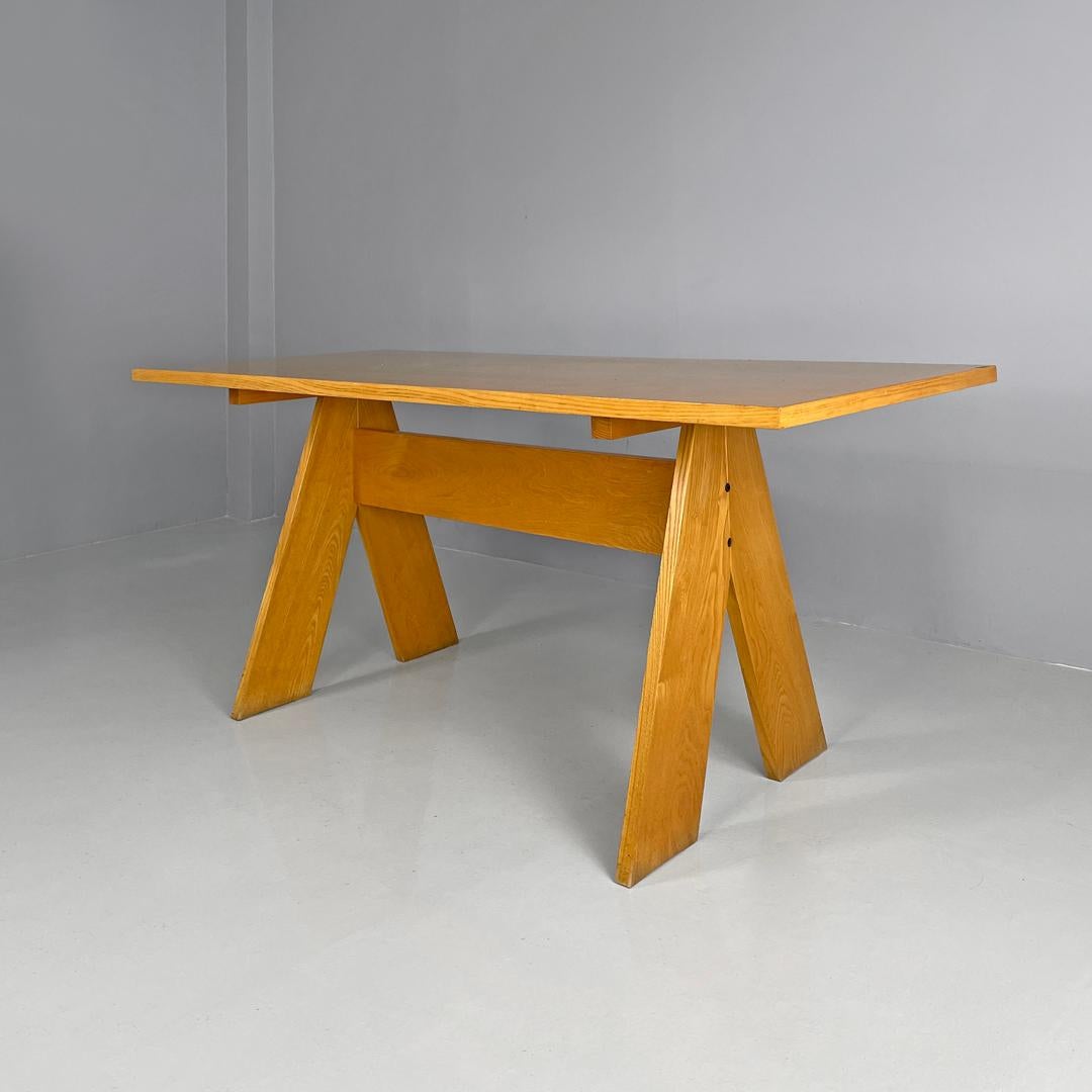 Italian modern wooden dining table by Gigi Sabadin for Stilwood, 1970s
Wooden dining table with rectangular top. The legs are made up of two diagonal strips that meet under the top and widen when they rest on the ground, resembling the shape of a