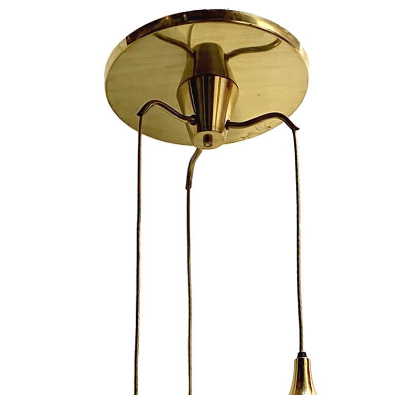 An Italian circa 1950s light fixture in bronze with porcelain pendant globes each with an interior light.

Measurements:
Diameter: 16