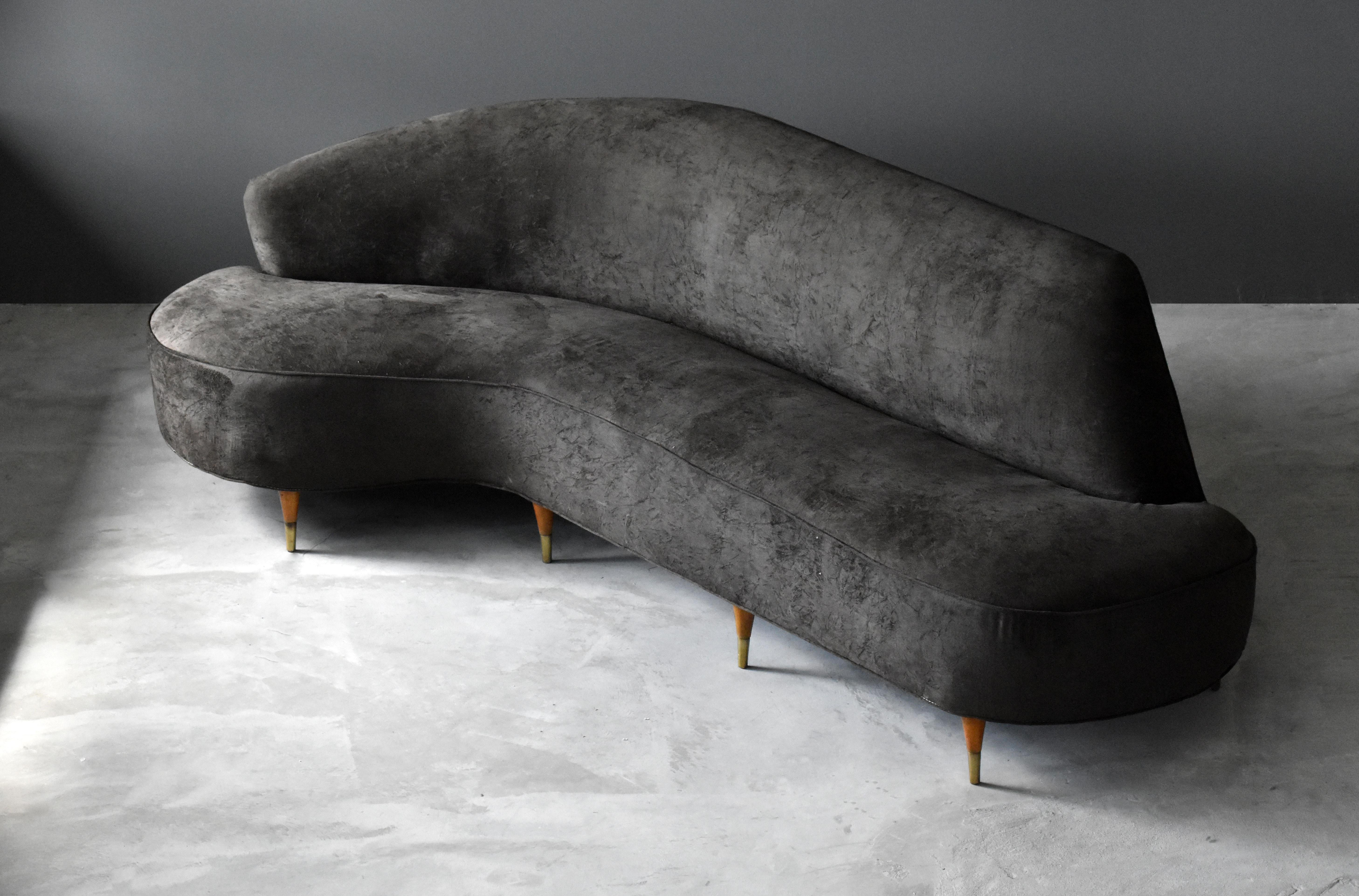 An organic / biomorphic and asymmetric sofa. Designed by an unknown Italian designer. Oak legs bear original brass caps,  upholstered in brown velvet fabric.

Other designers of the period include Federico Munari, Gio Ponti, Ico & Luisa Parisi,