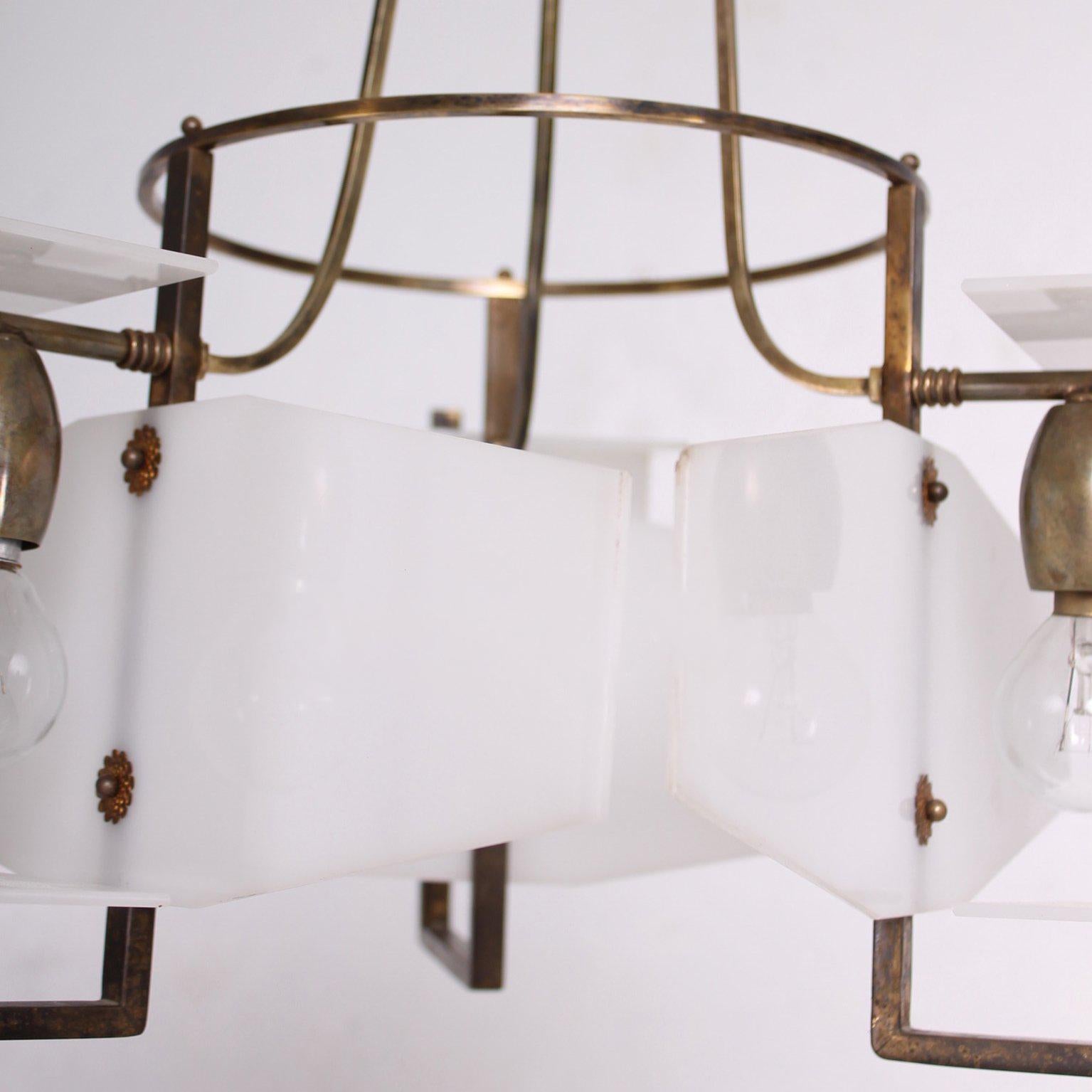 For your consideration a vintage modern chandelier made in Italy. Constructed with brass and plexiglass in white color. 

The chandelier has been rewired and it is ready to go. The brass has a beautiful brown patina. The plexiglass is the original