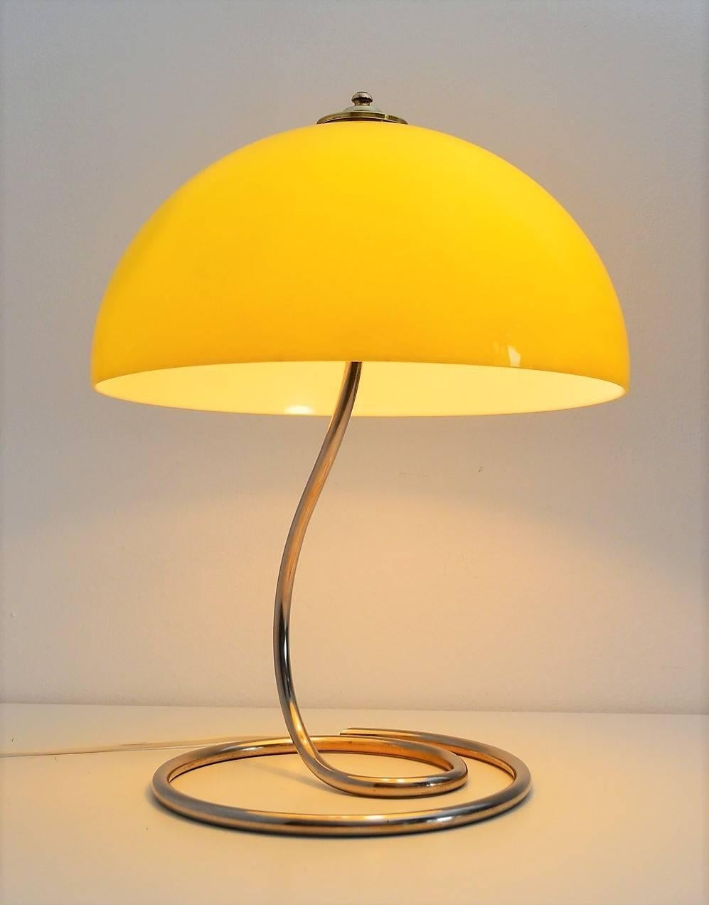 Beautiful and rare Space Age table or desk lamp with acrylic hood in shiny yellow color. Very Pop style.
The lamp is made of a strong full brass lamp stand and a big hood made of shiny yellow acrylic with brass decoration on the top.
Inside the