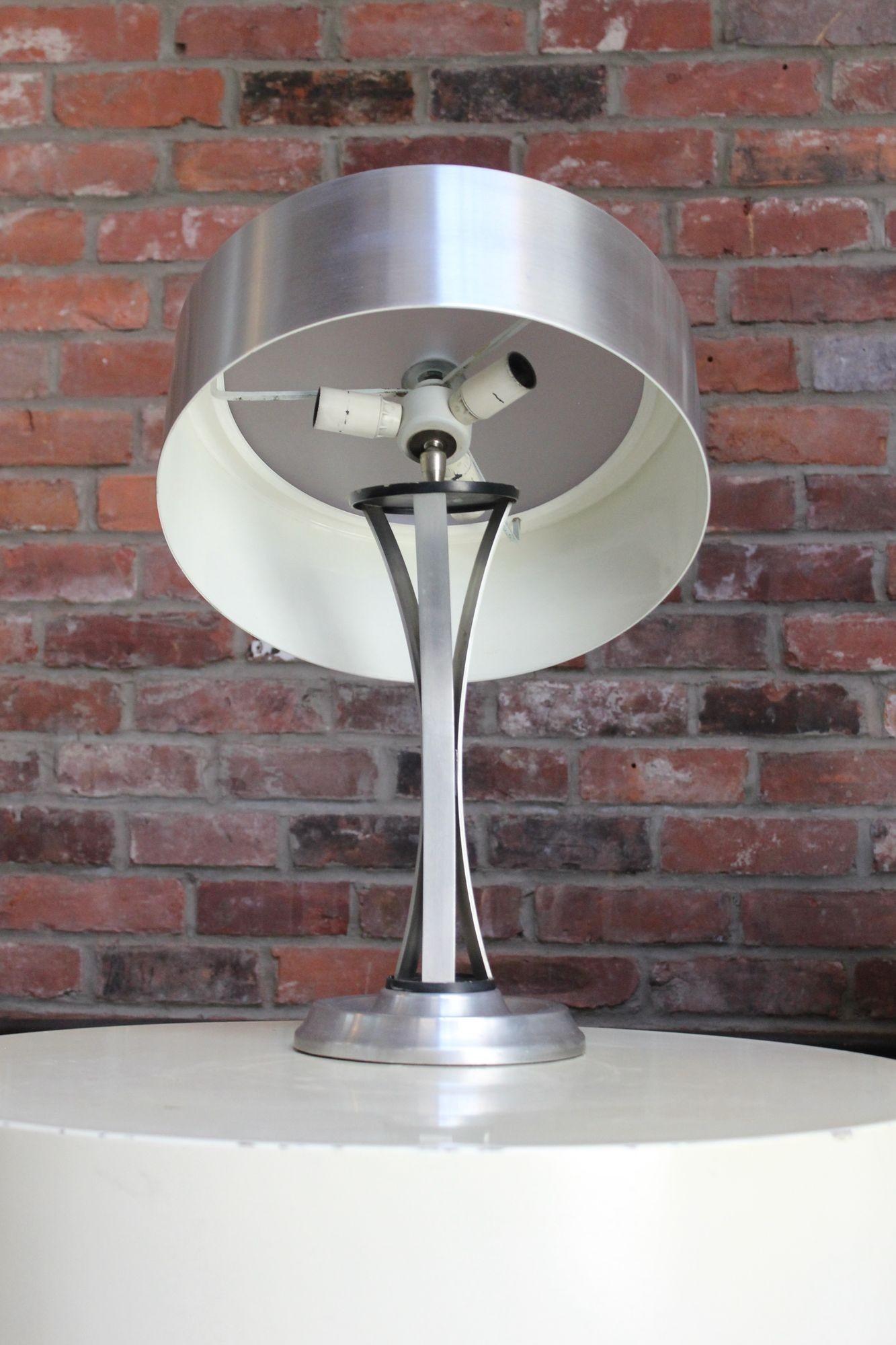 Polished aluminum table lamp with inset frosted glass shade by Oscar Torlasco for Lumi (Italy, ca. 1960s).
Ingenious design, marrying form and function designed with a useful adjustability function without compromising style. Specifically, there is