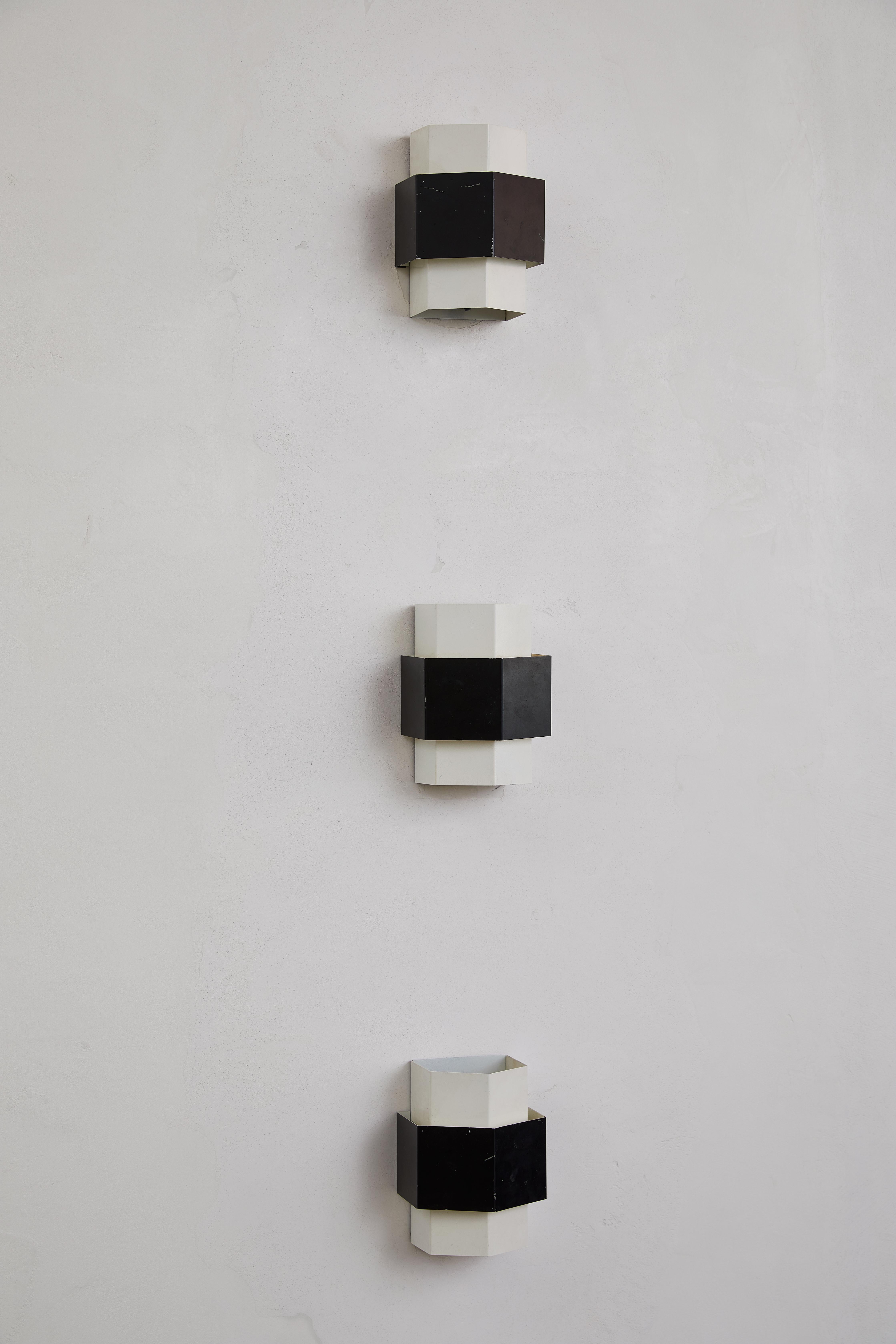A striking set of three Anvia wall sconces, these pieces were designed by J.J.M. Hoogervorst, a notable figure in Dutch modernism celebrated for his functional yet sculptural lighting designs. Crafted in the 1950s-60s, each sconce boasts a sleek,