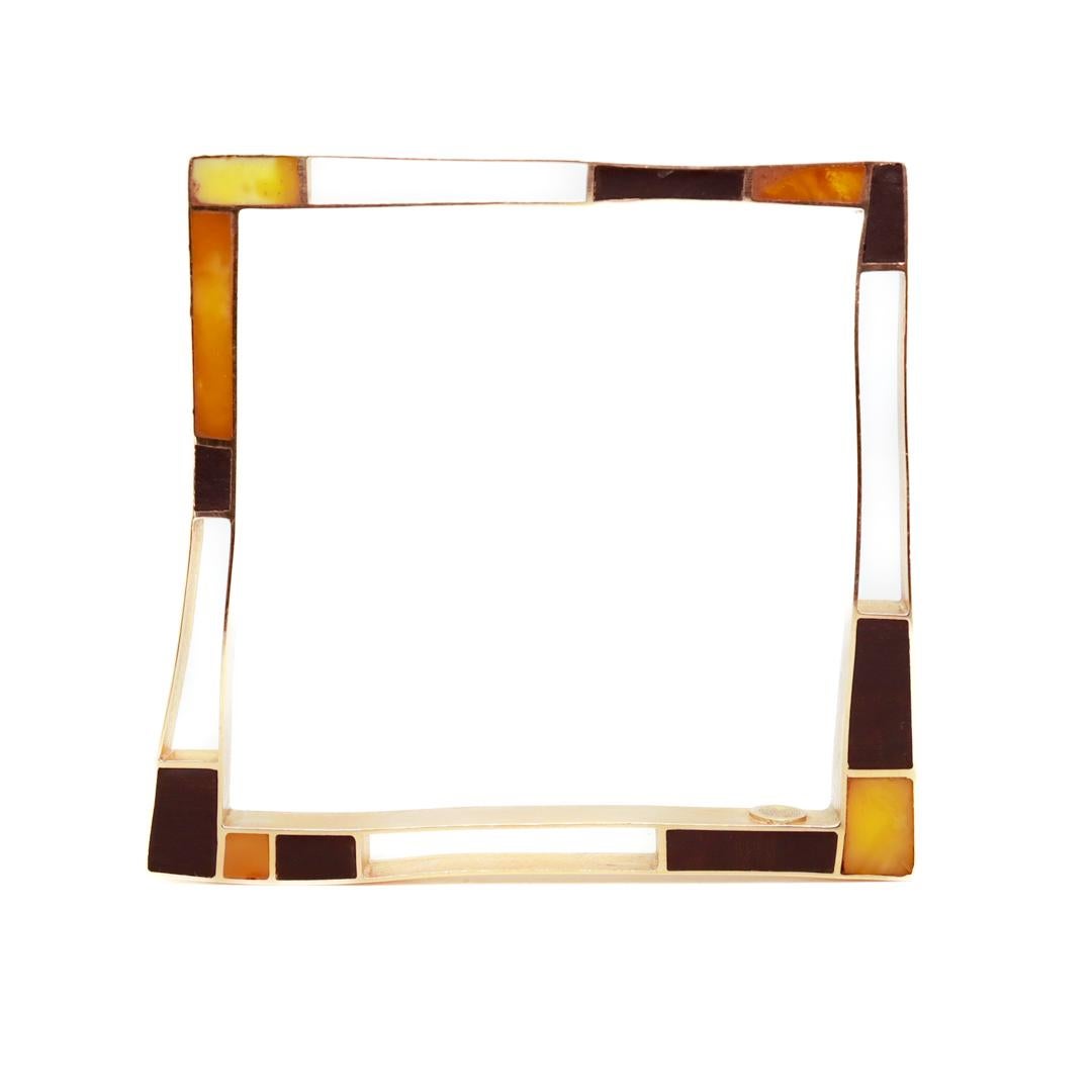An exciting Modernist bracelet.

In 18 karat gold with inlaid ebony and amber.

Marked for the Venetian goldsmiths - Ardit Sas Di Ardit Alberto & Co.

The bracelet is roughly square with an asymmetrical design. 

Simply an eye-catching