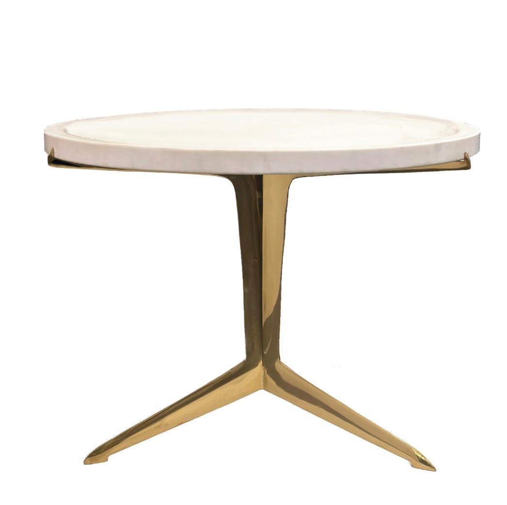 Make any space stylish with this striking modernist side table, a sophisticated blend of natural elegance and sculptural form. Featuring an almost pure white marble top and a sleek, brass tripod base, this piece exudes style and refined