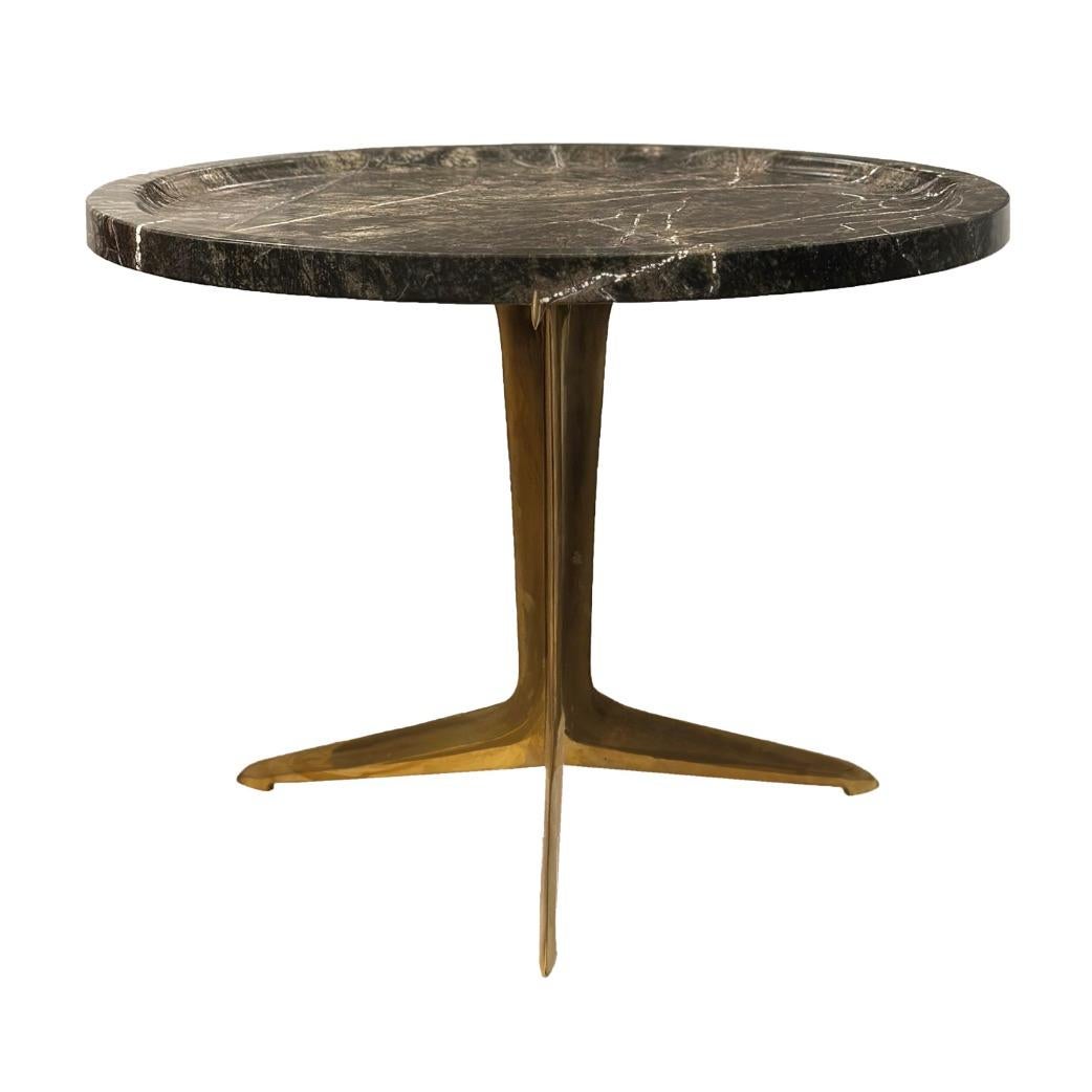 Make any space stylish with this striking modernist side table, a sophisticated blend of natural elegance and sculptural form. Featuring a richly veined marble top and a sleek, brass tripod base, this piece exudes style and refined craftsmanship.