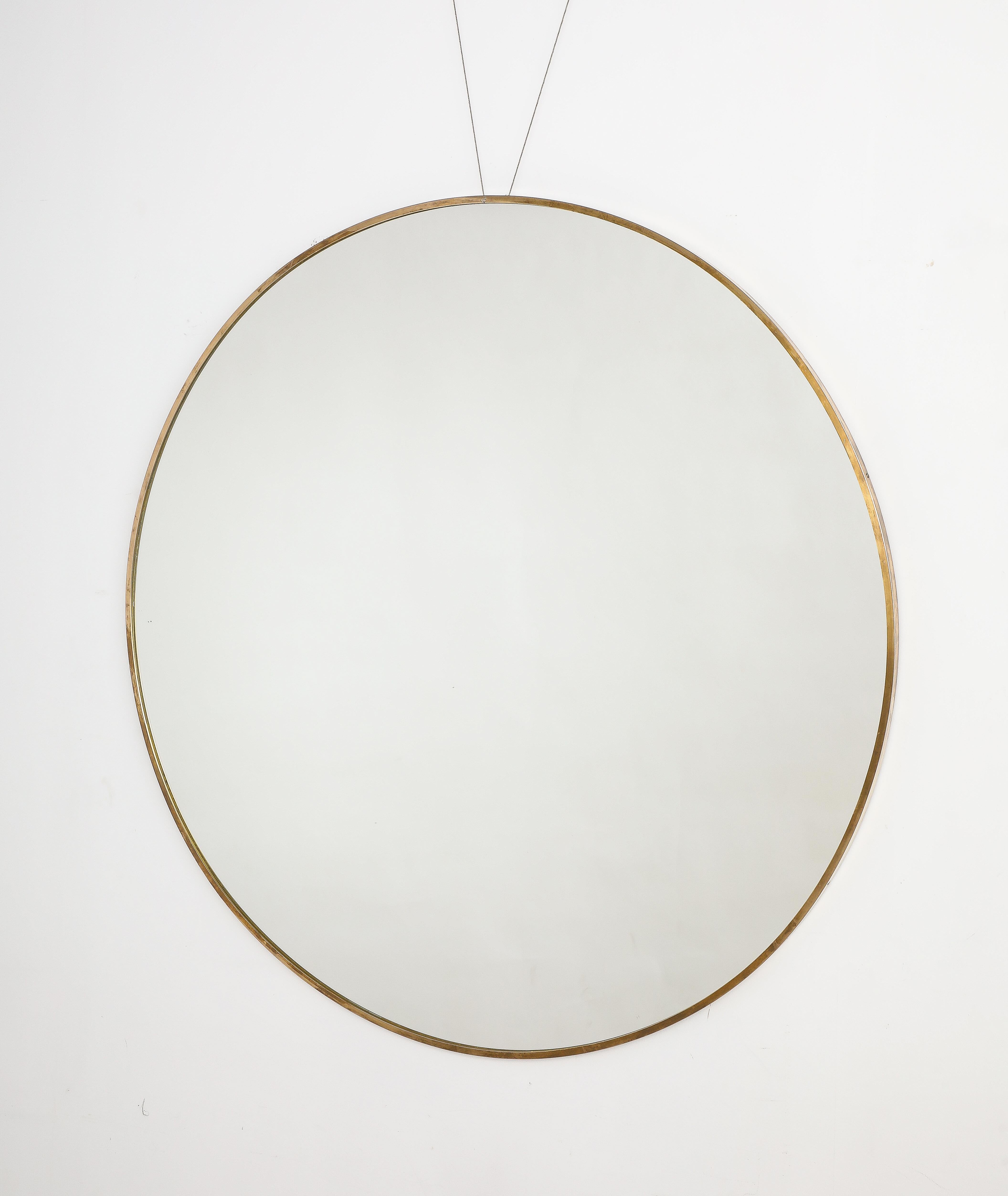 A rare grand scale Italian modernist brass circular mirror.  With wonderful patina, dramatic in size.  Would be a wonderful addition to any interior style.
Italy, circa 1950 
Size: 45 1/2