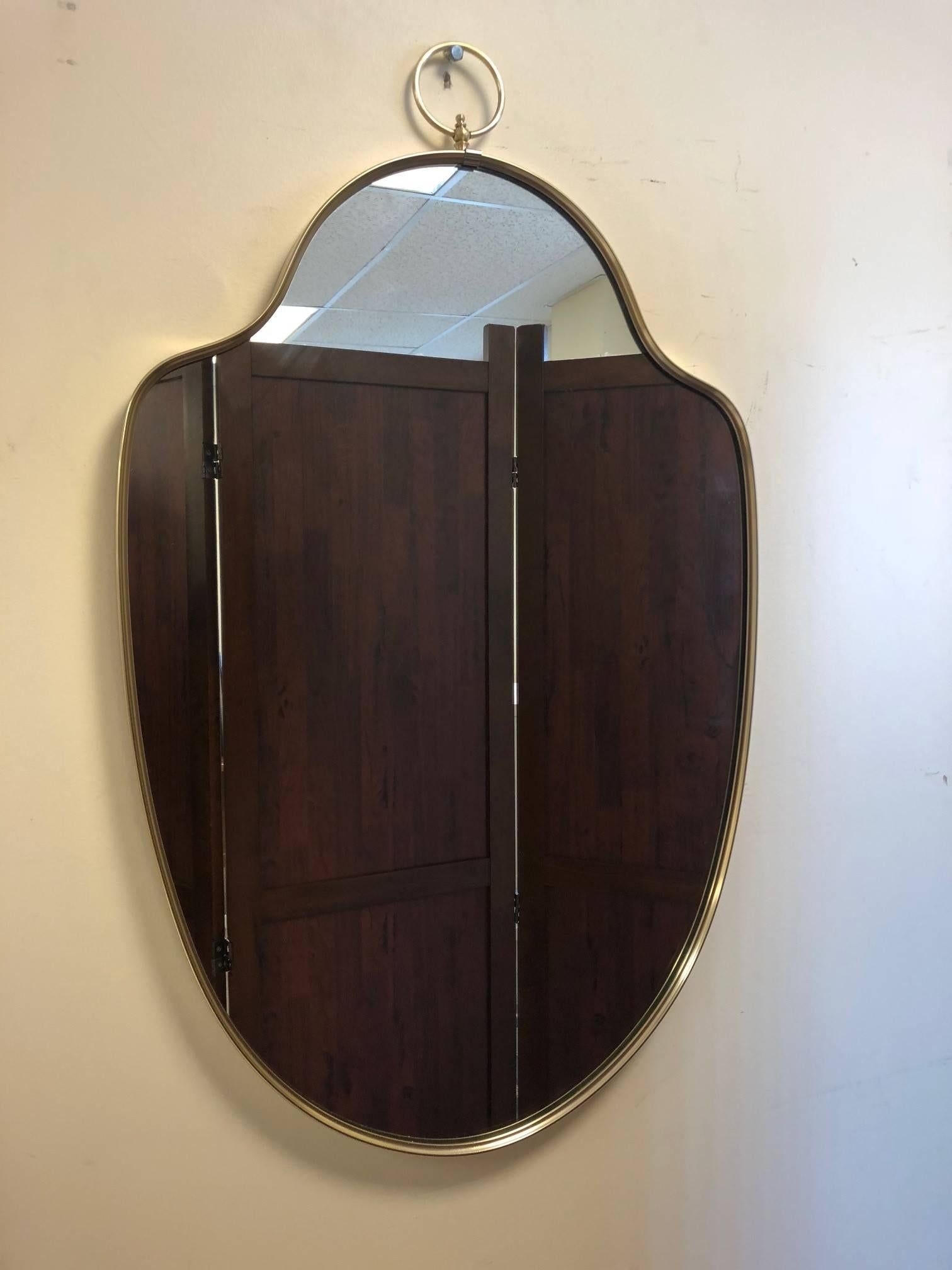 Hollywood Regency Italian Modernist Brass Mirror with a Decorative Ring at the Top For Sale